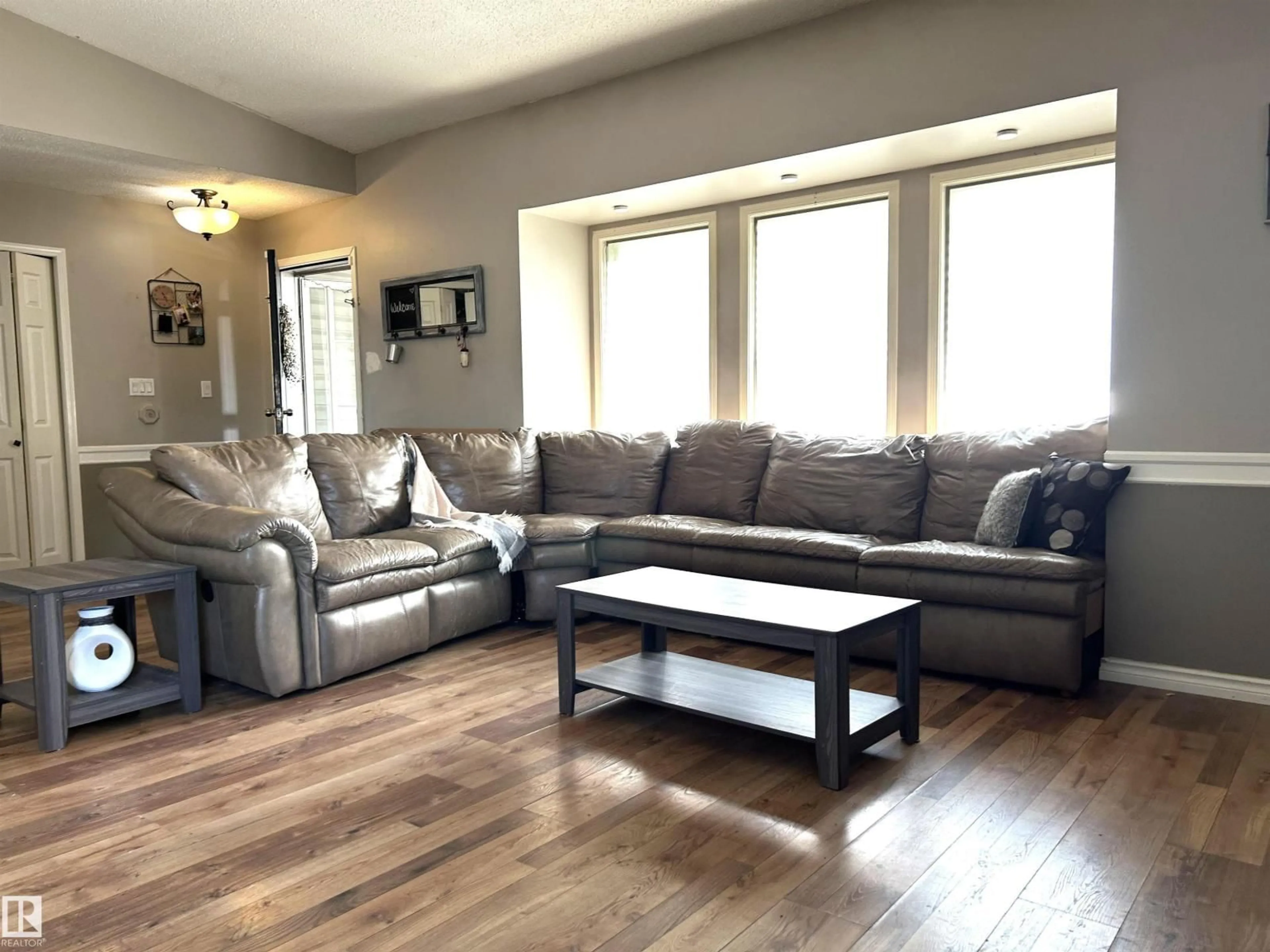 Living room with furniture, wood/laminate floor for 166 WEST LIBERTY CR, Millet Alberta T0C1Z0