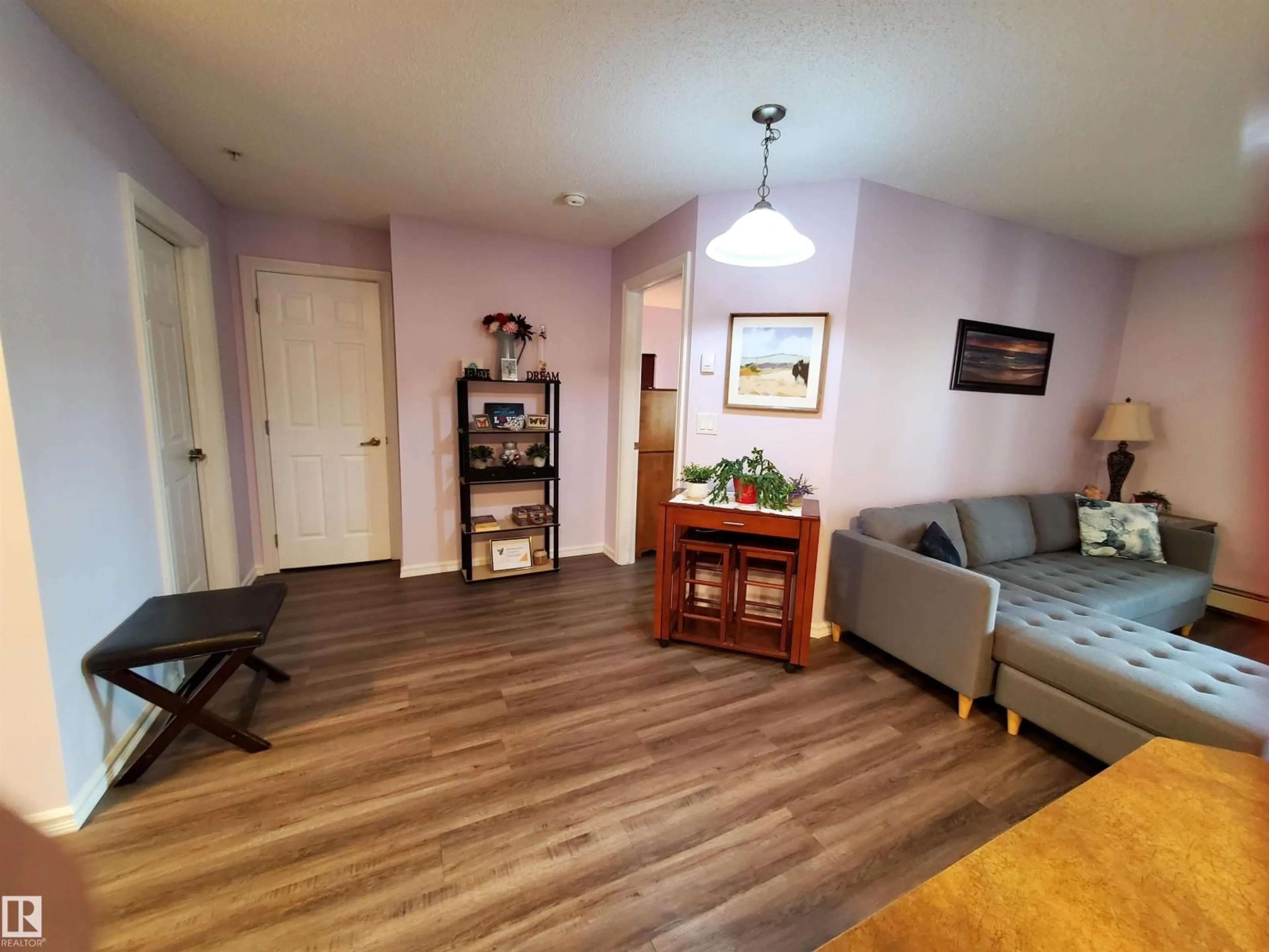 Living room with furniture, wood/laminate floor for #109 - 4403 23 ST, Edmonton Alberta T6T1E4