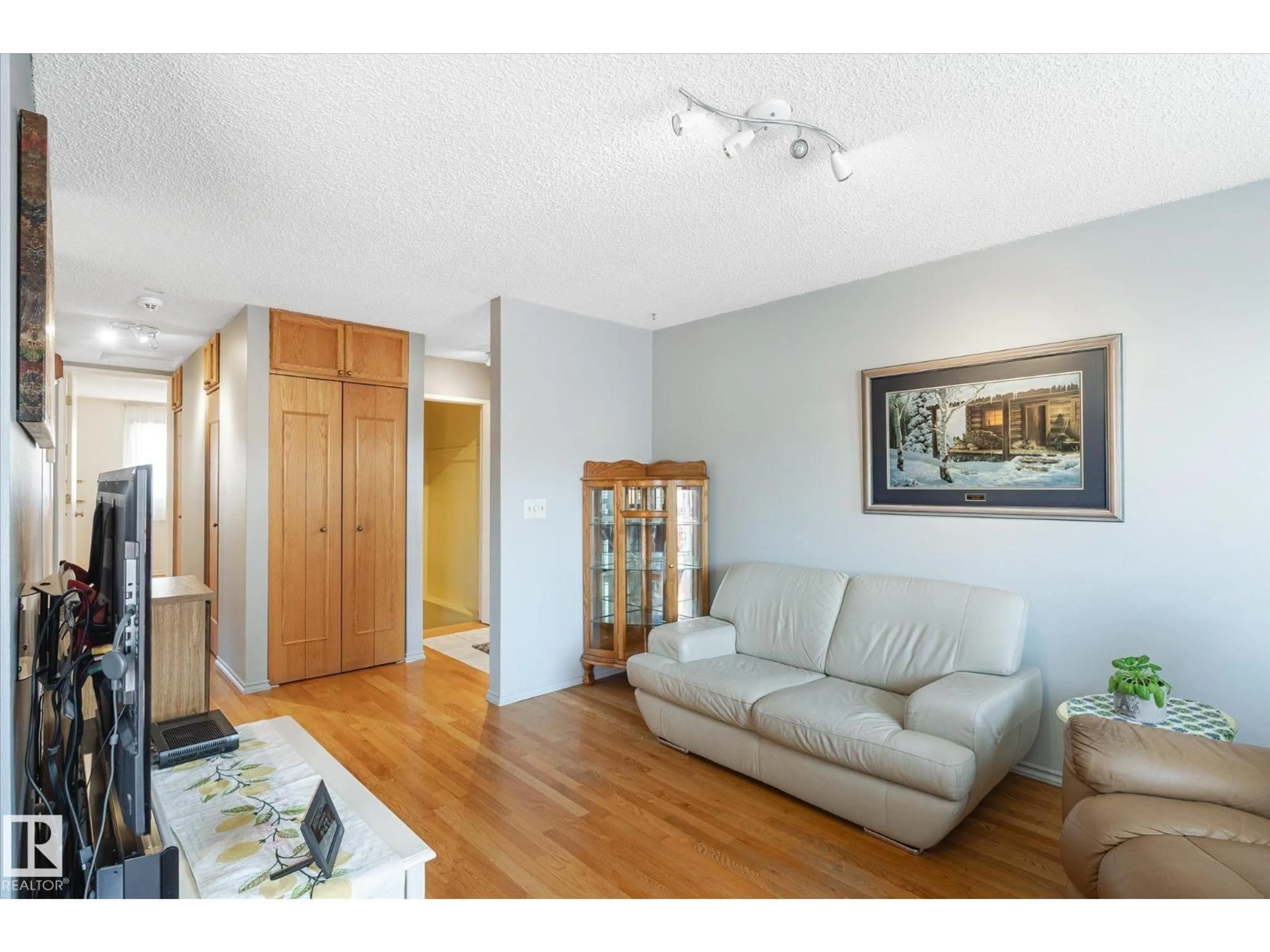 Living room with furniture, wood/laminate floor for #111 - 16725 106 ST, Edmonton Alberta T5X5G5