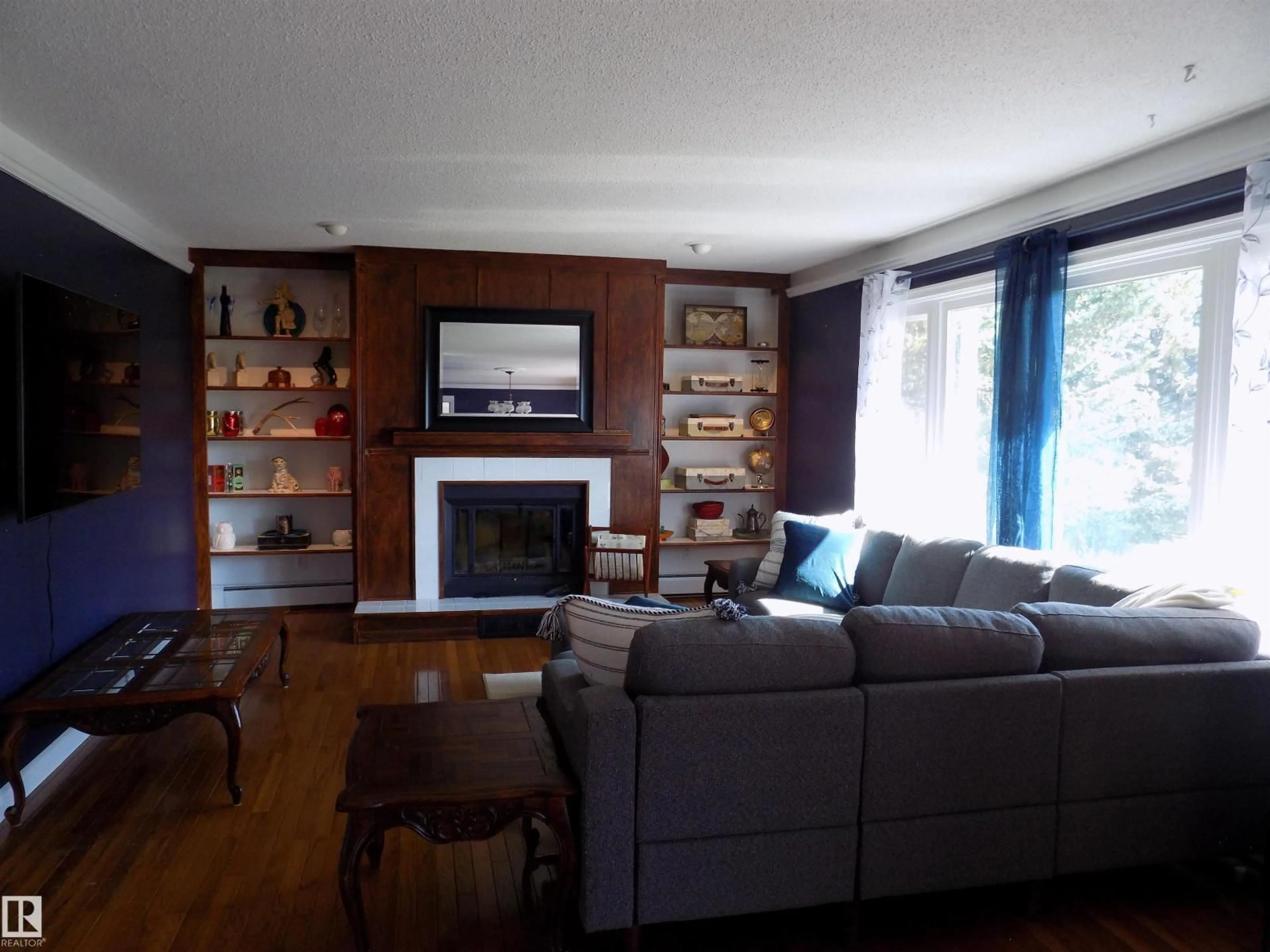 Living room with furniture, wood/laminate floor for 43 - 464079 RGE RD 244, Rural Wetaskiwin County Alberta T9A1X1
