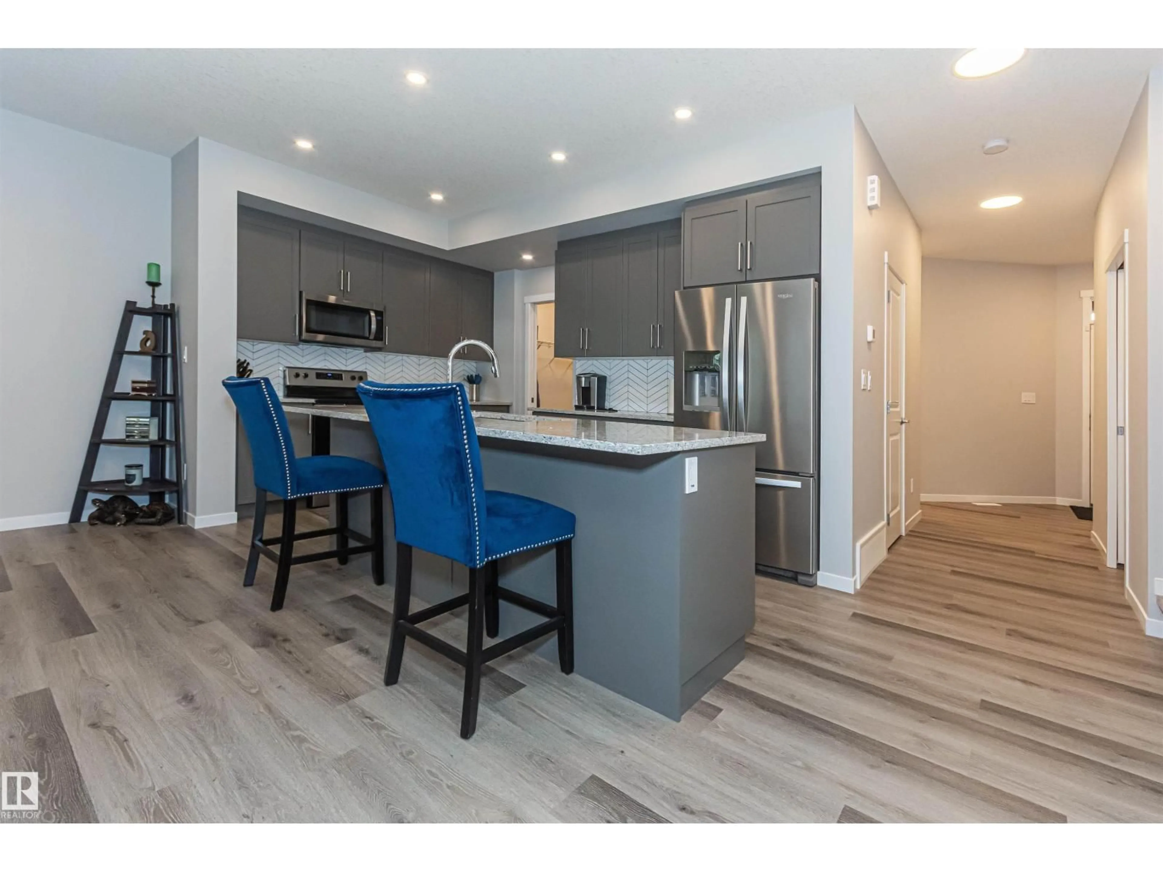 Open concept kitchen, wood/laminate floor for 1395 SECORD LANDING LD, Edmonton Alberta T5T7A7