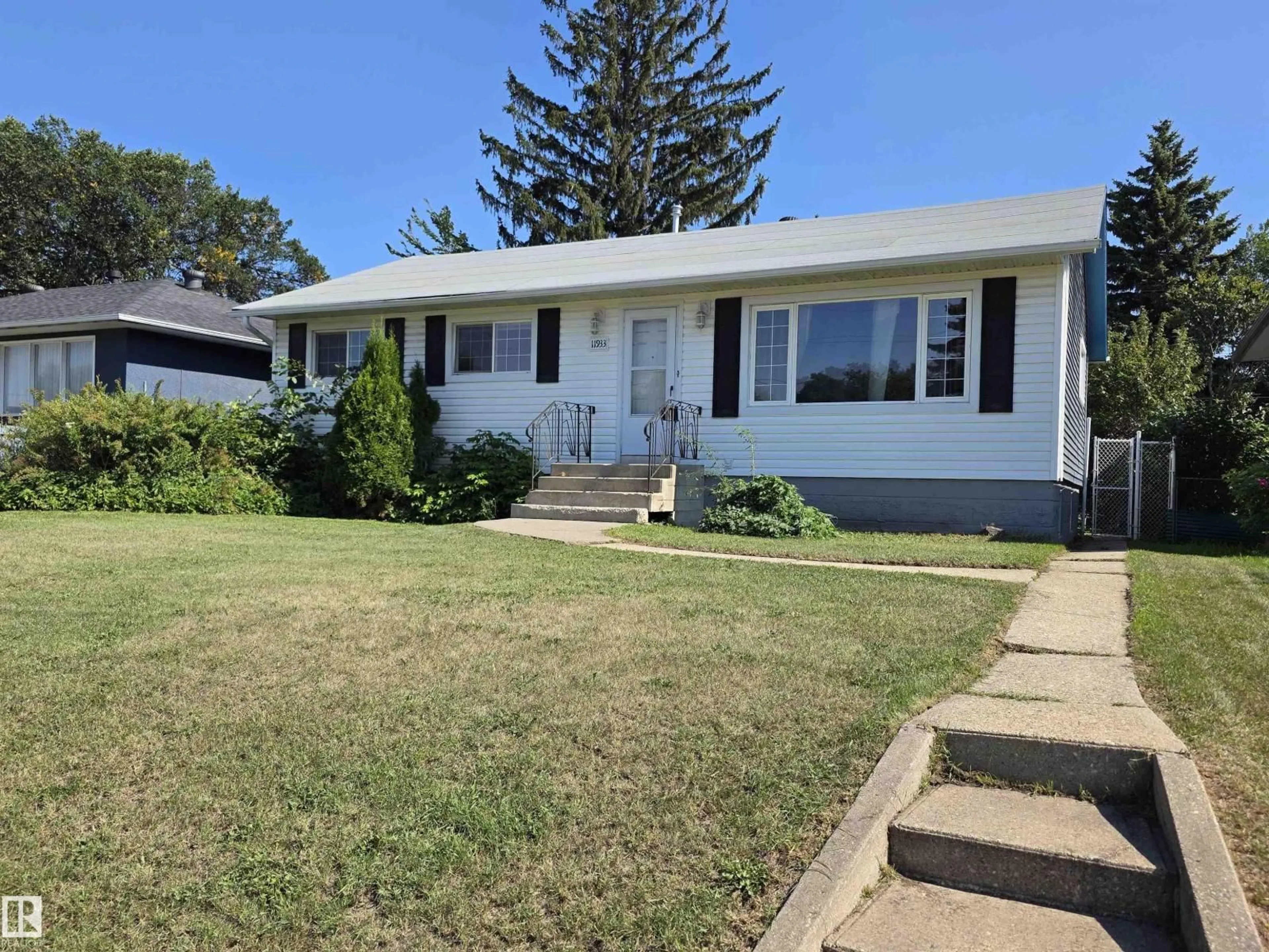 Home with vinyl exterior material, street for NW - 11933 50 ST, Edmonton Alberta T5W3C1
