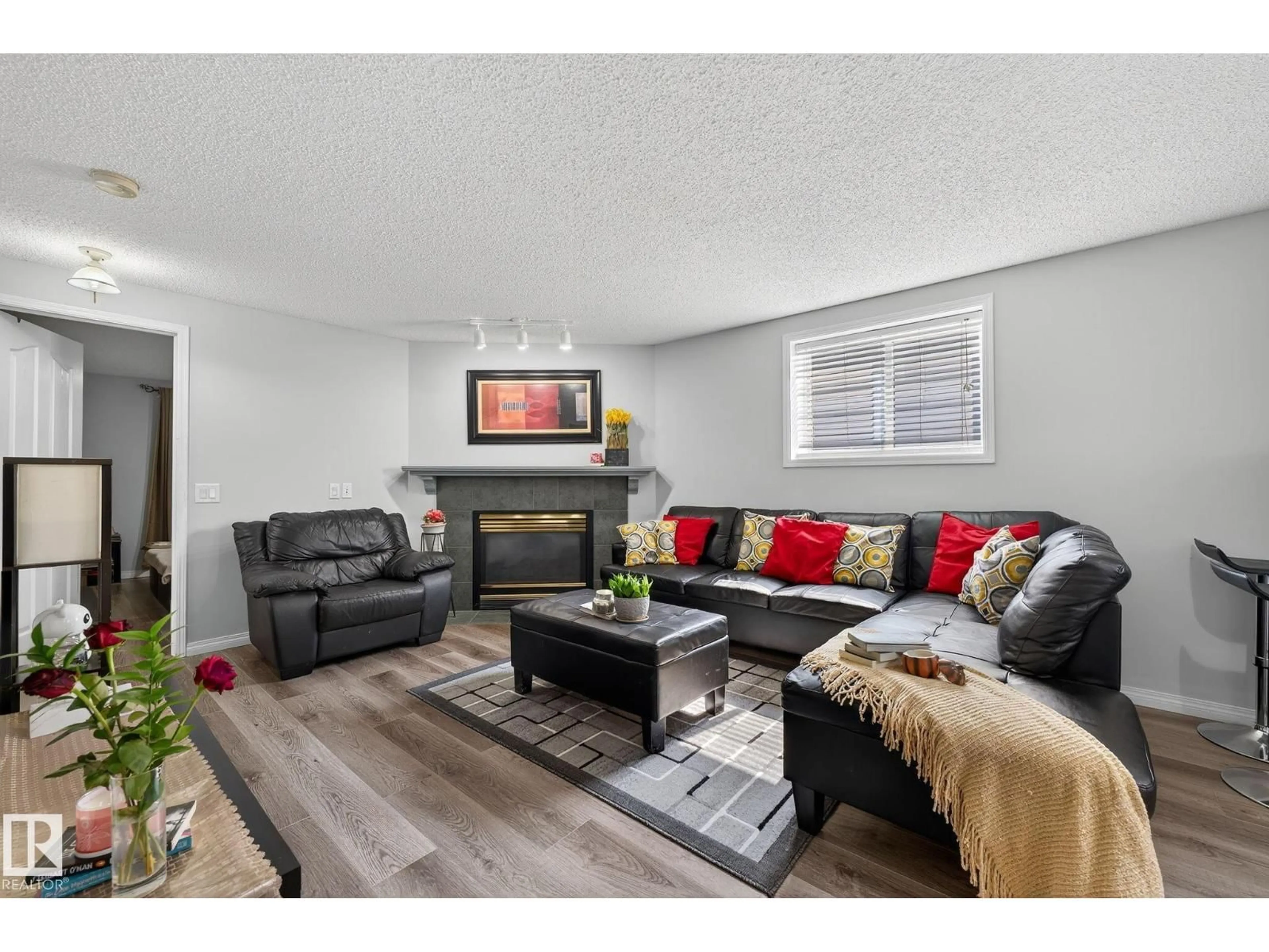 Living room with furniture, wood/laminate floor for 1051 JONES CR, Edmonton Alberta T6L6Y1