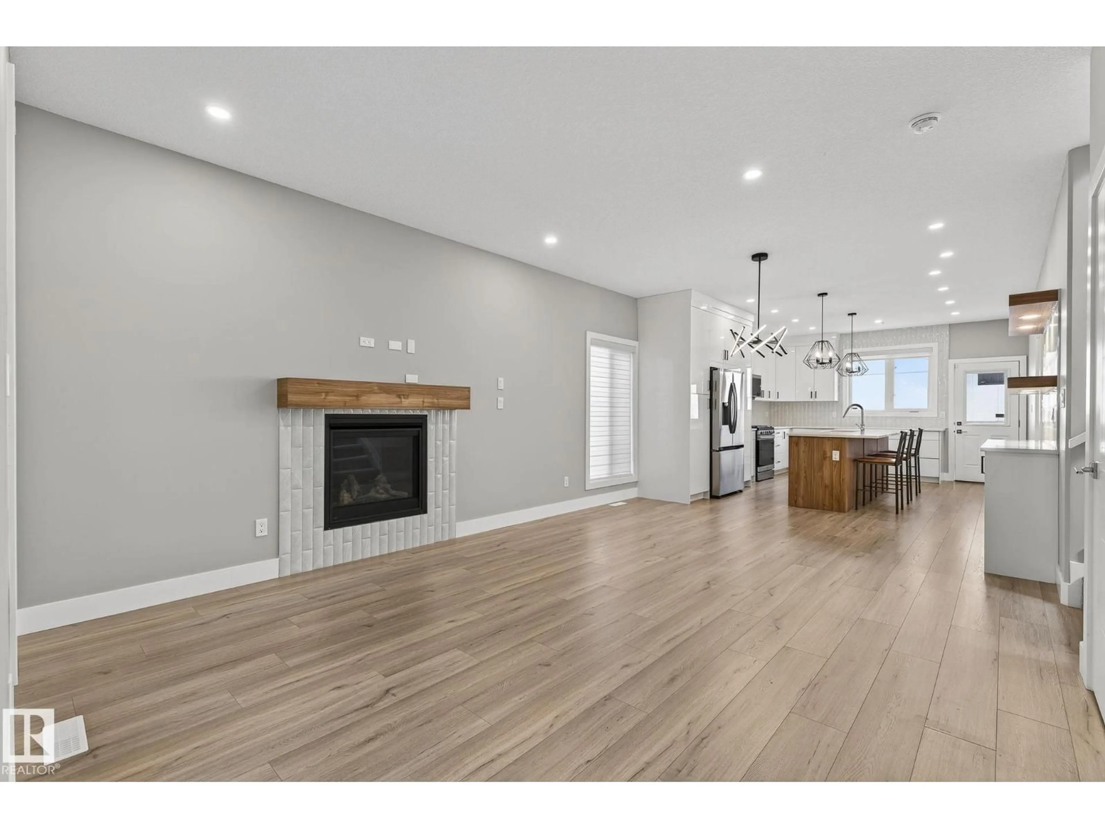 Open concept kitchen, wood/laminate floor for 10906 54 AV, Edmonton Alberta T6H0V1