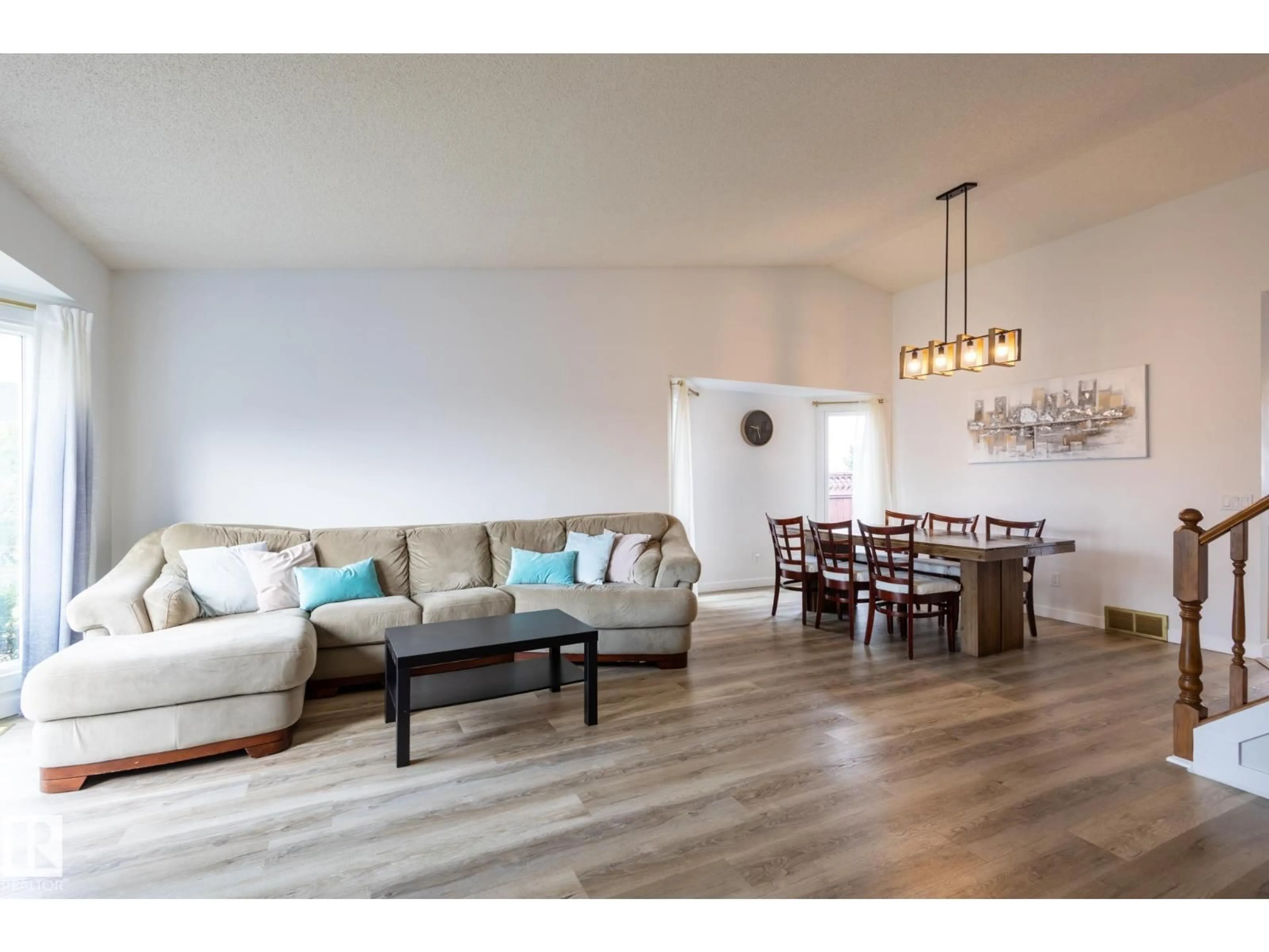 Living room with furniture, wood/laminate floor for 7640 158A AV, Edmonton Alberta T5Z2V8