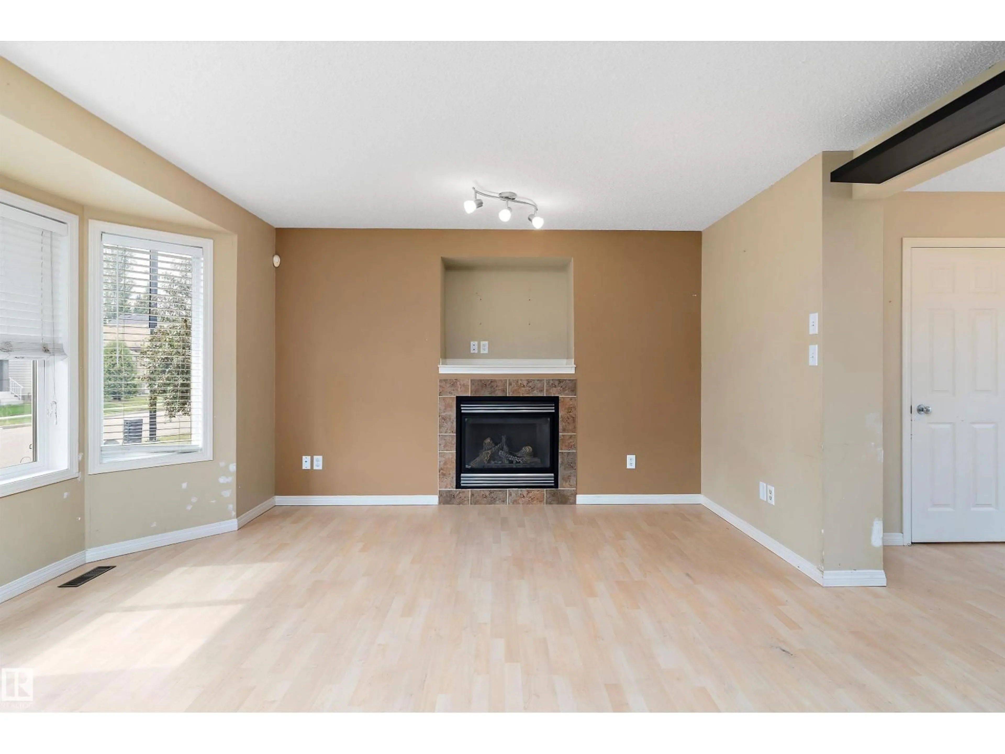 Living room with furniture, wood/laminate floor for 2330 29A AV, Edmonton Alberta T6T2B1