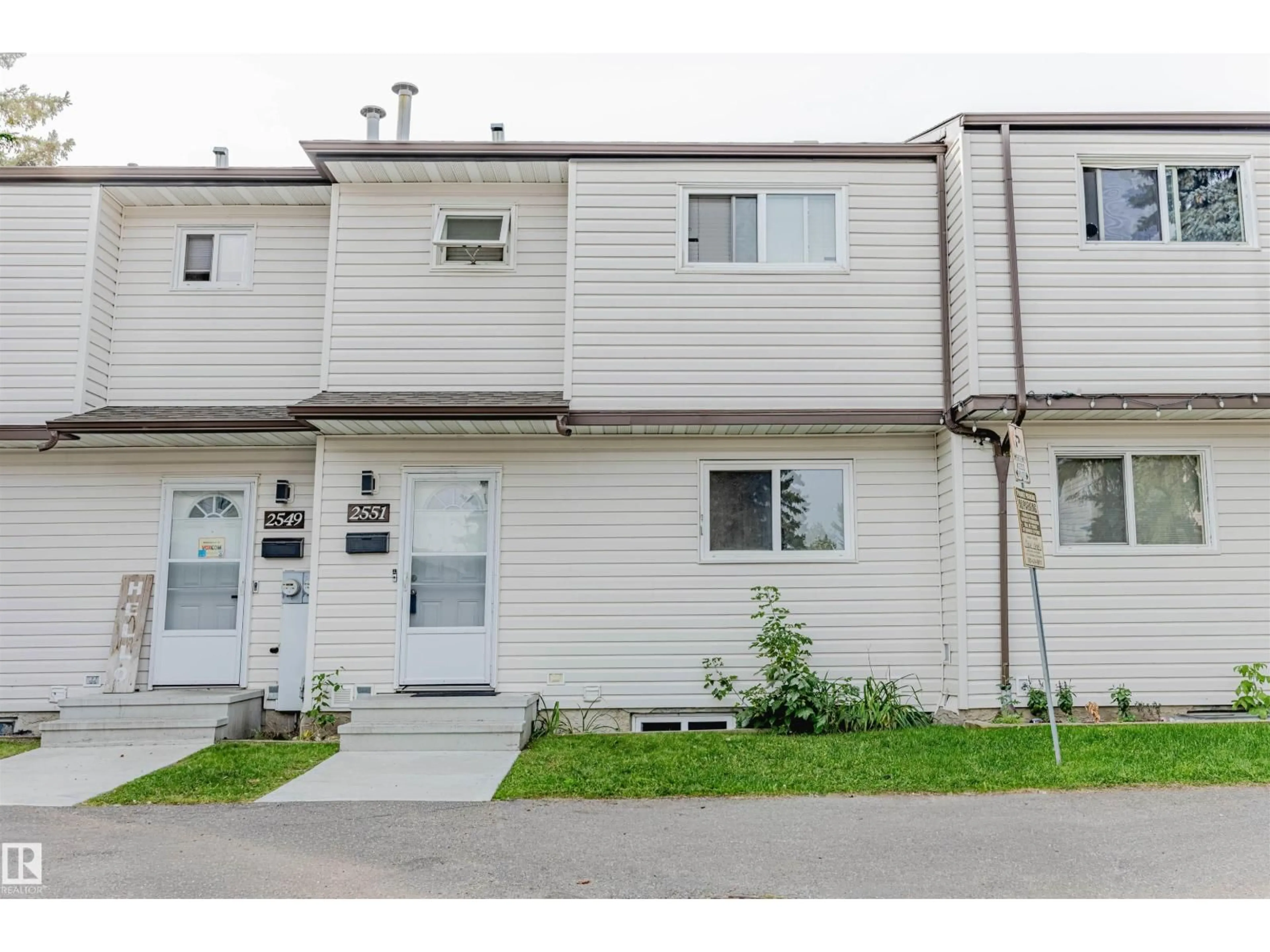 Home with vinyl exterior material, street for 2551 135 AV NW, Edmonton Alberta T5A3S5
