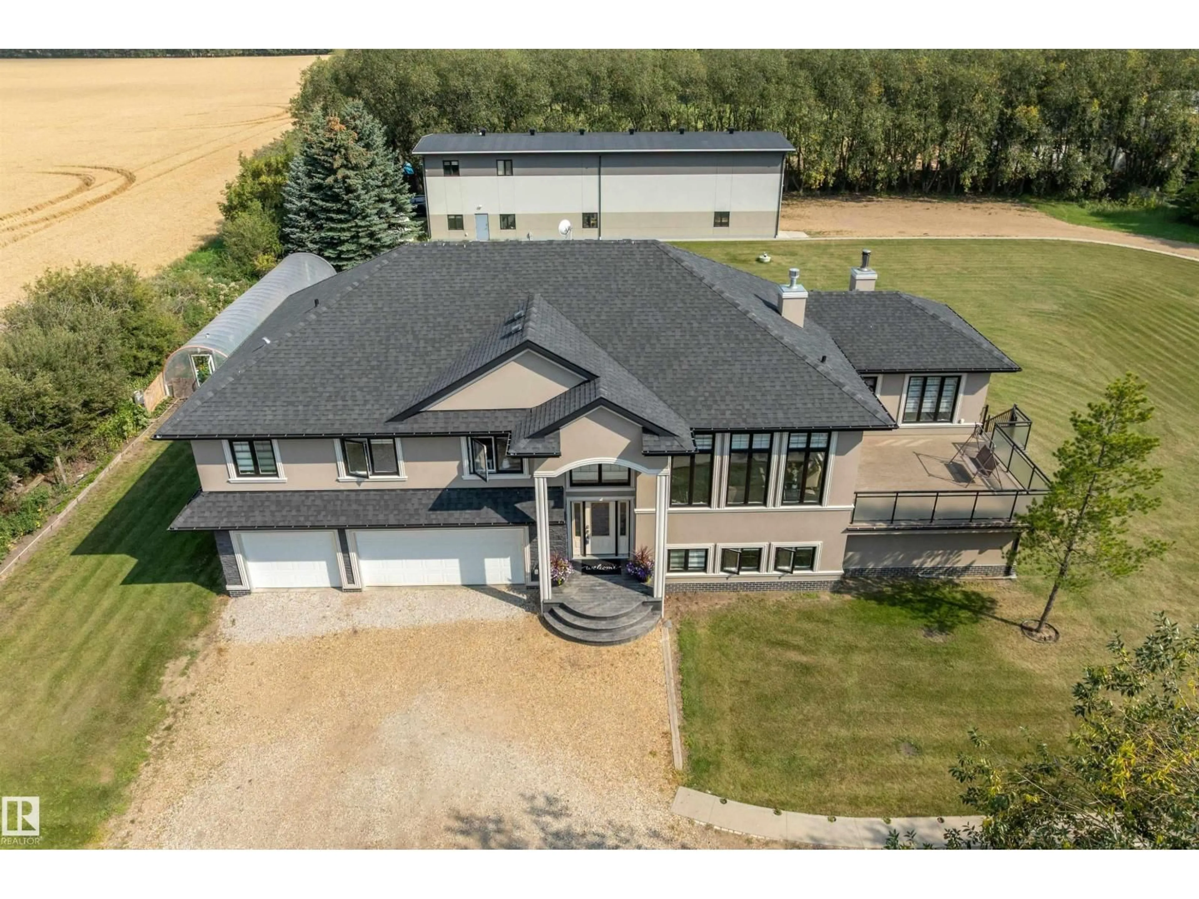 A pic from outside/outdoor area/front of a property/back of a property/a pic from drone, building for 9B - 54231 RANGE ROAD 250, Rural Sturgeon County Alberta T8T0C2