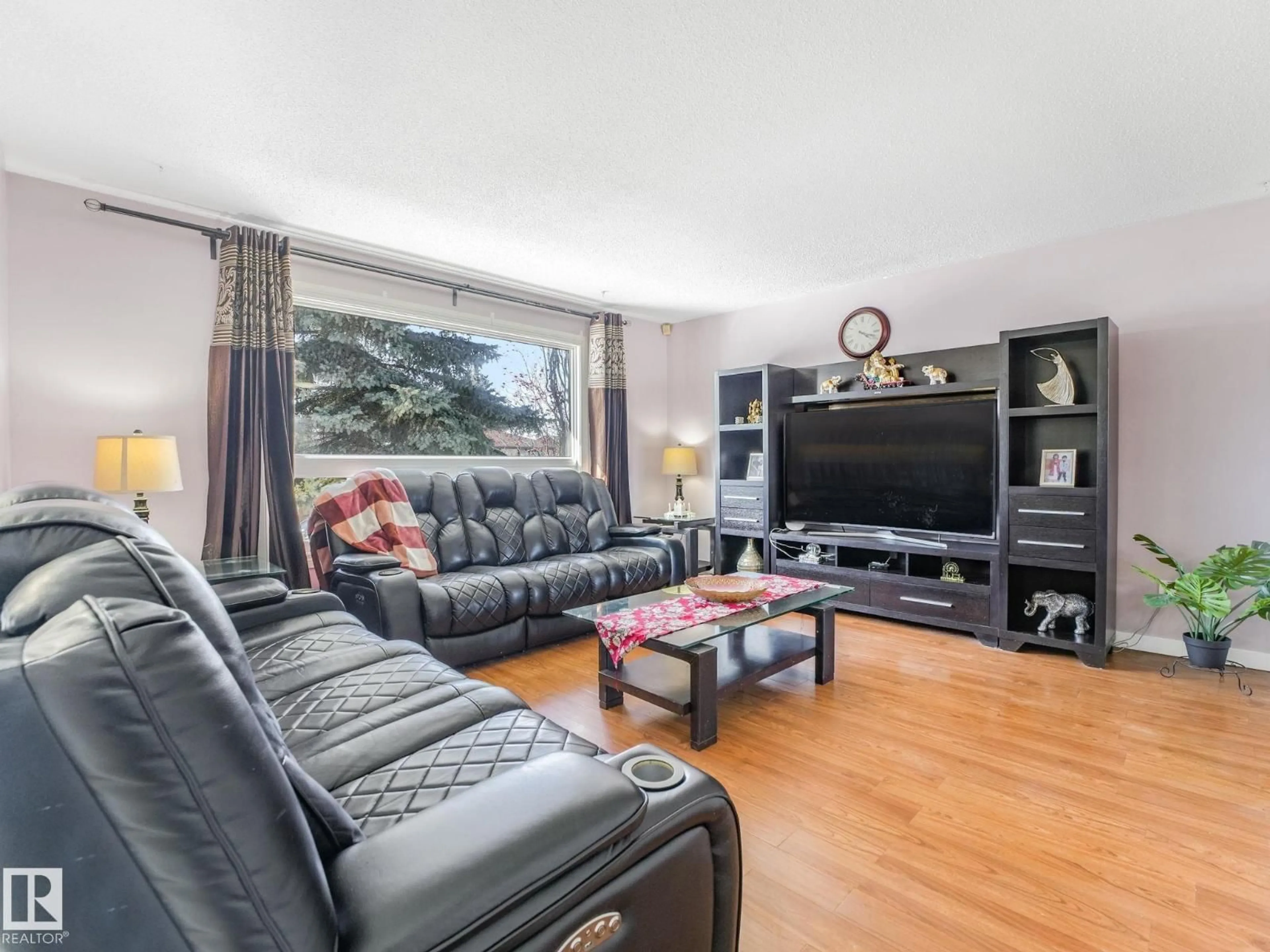 Living room with furniture, wood/laminate floor for NW - 16531 116 ST, Edmonton Alberta T5X4B2