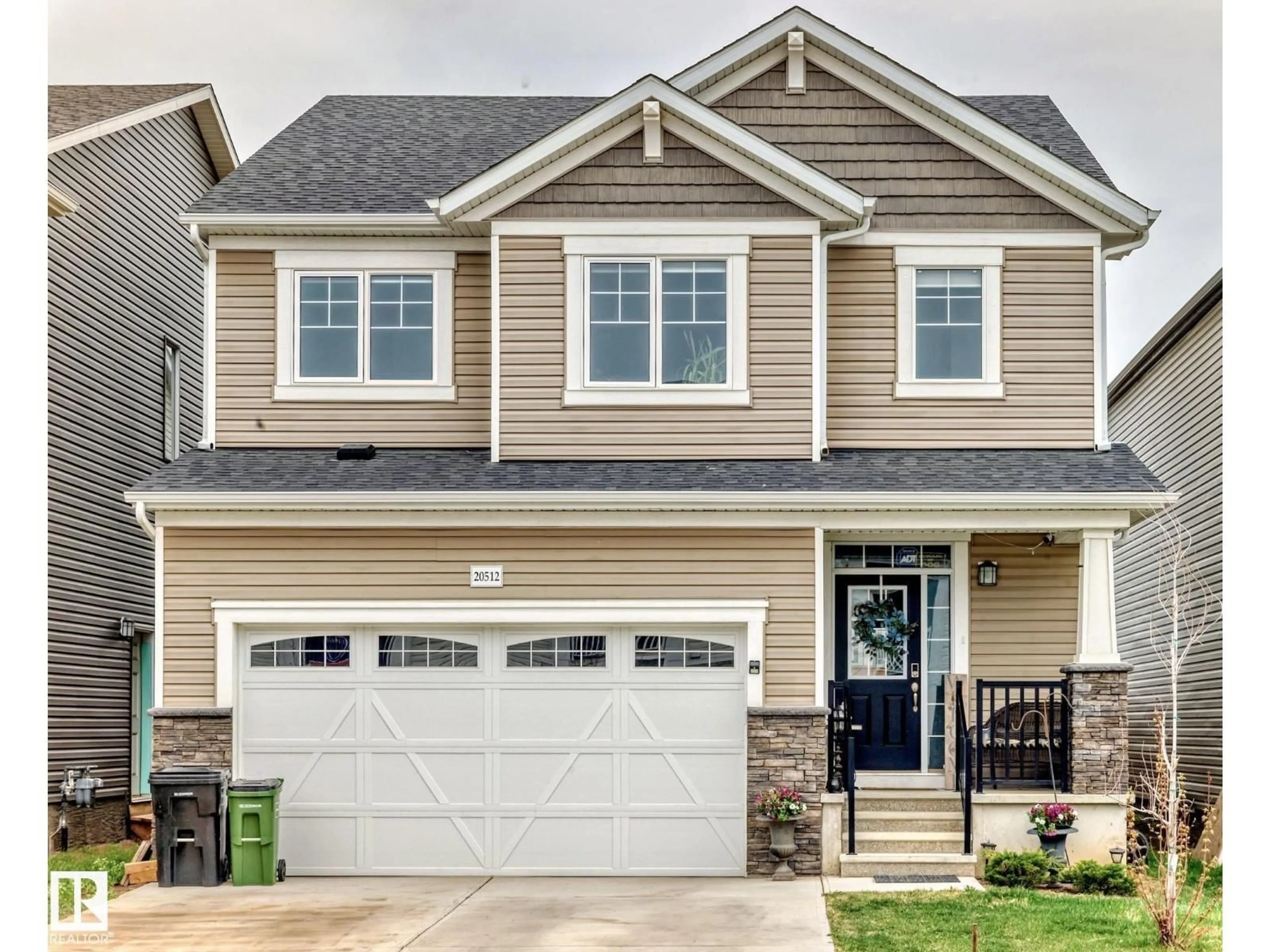 Home with vinyl exterior material, street for 20512 22 AV, Edmonton Alberta T6M1N1