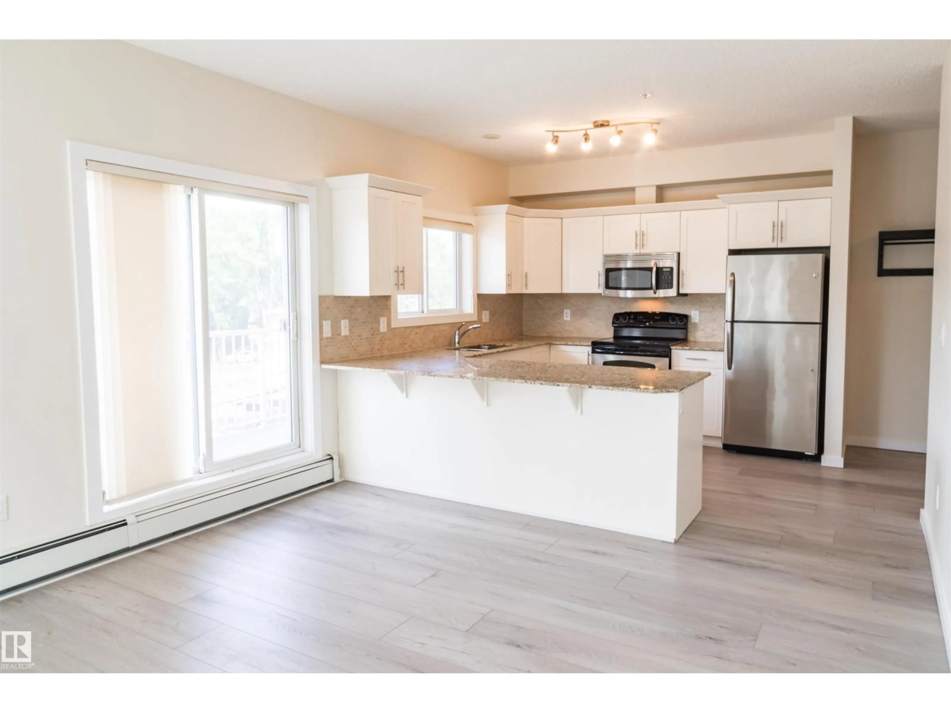 Open concept kitchen, wood/laminate floor for 304 - 10524 77 AV, Edmonton Alberta T6E1N1