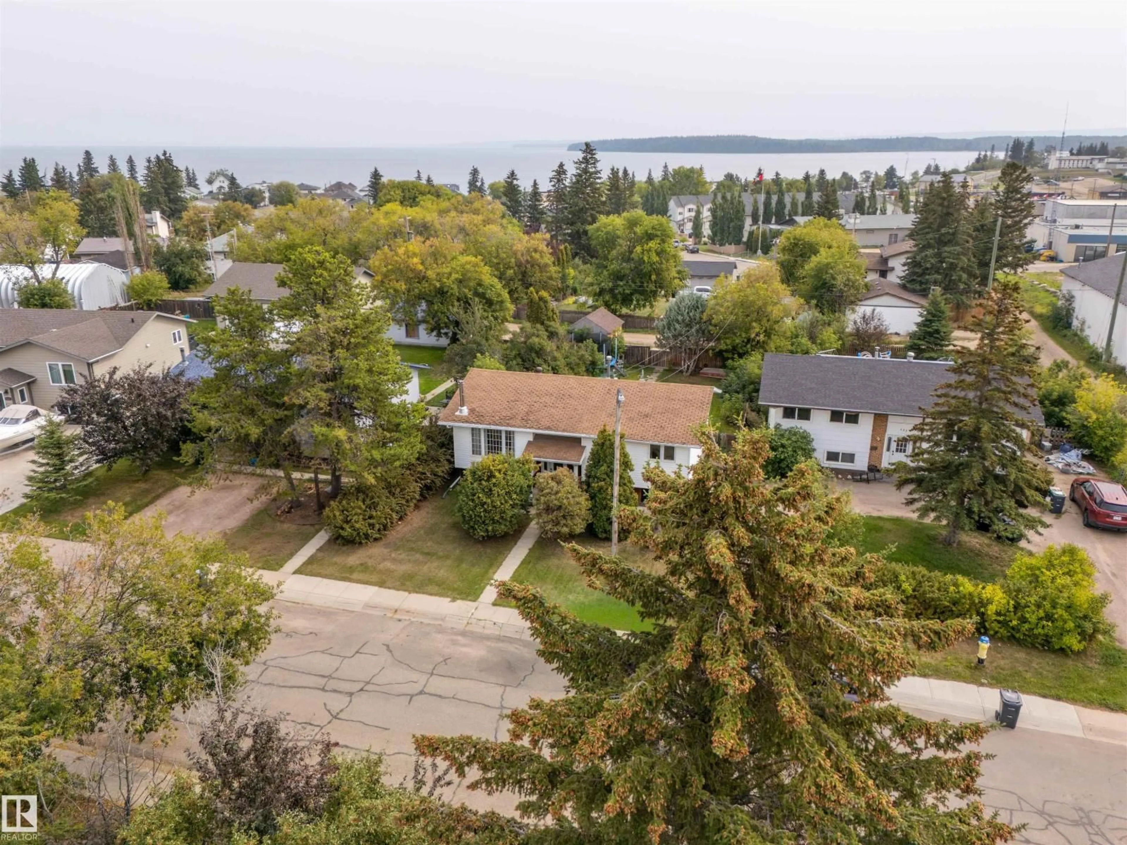 A pic from outside/outdoor area/front of a property/back of a property/a pic from drone, water/lake/river/ocean view for 620 13 ST, Cold Lake Alberta T9M1B2