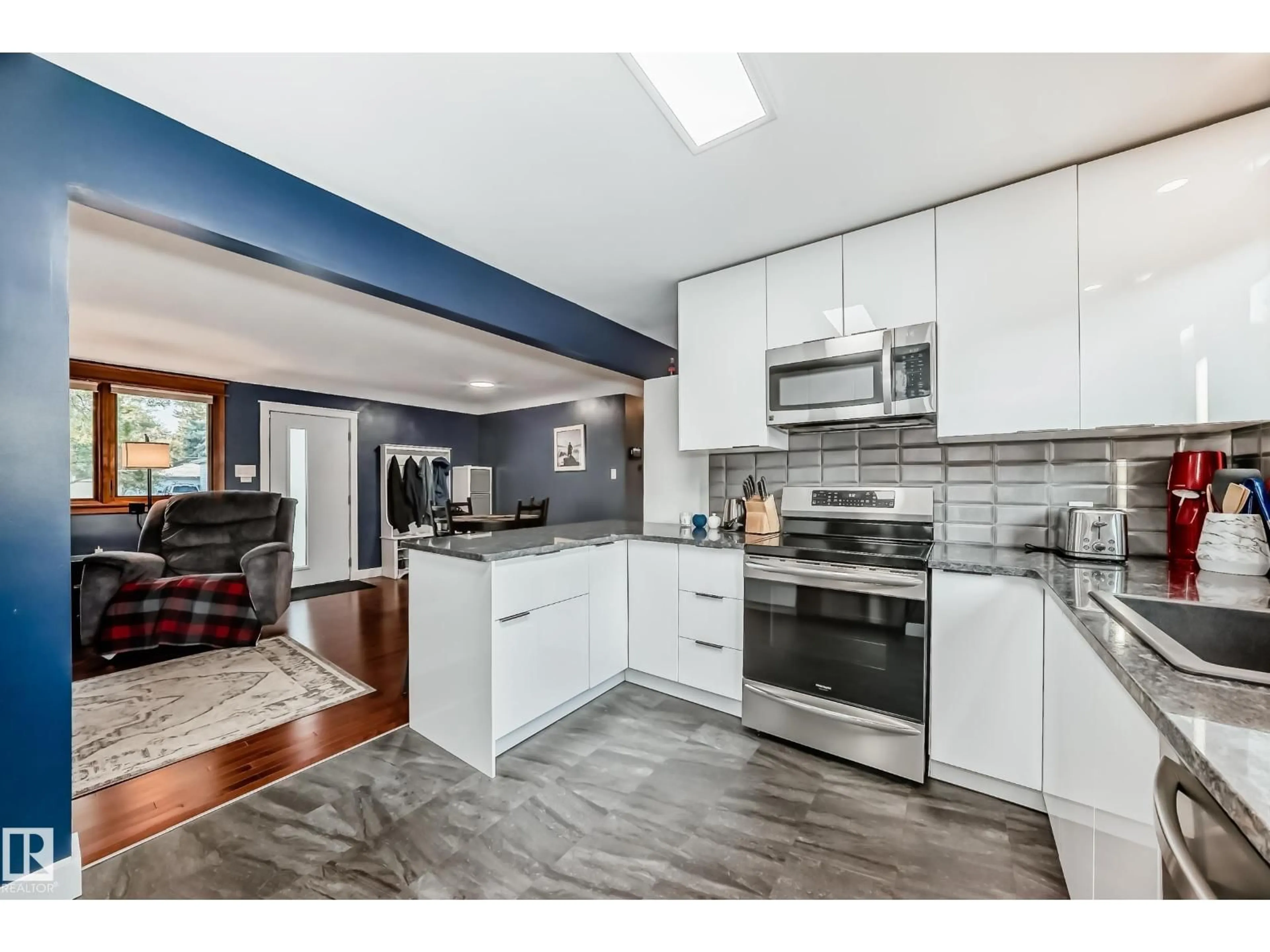 Open concept kitchen, wood/laminate floor for 7712 86 AV, Edmonton Alberta T6C1H8