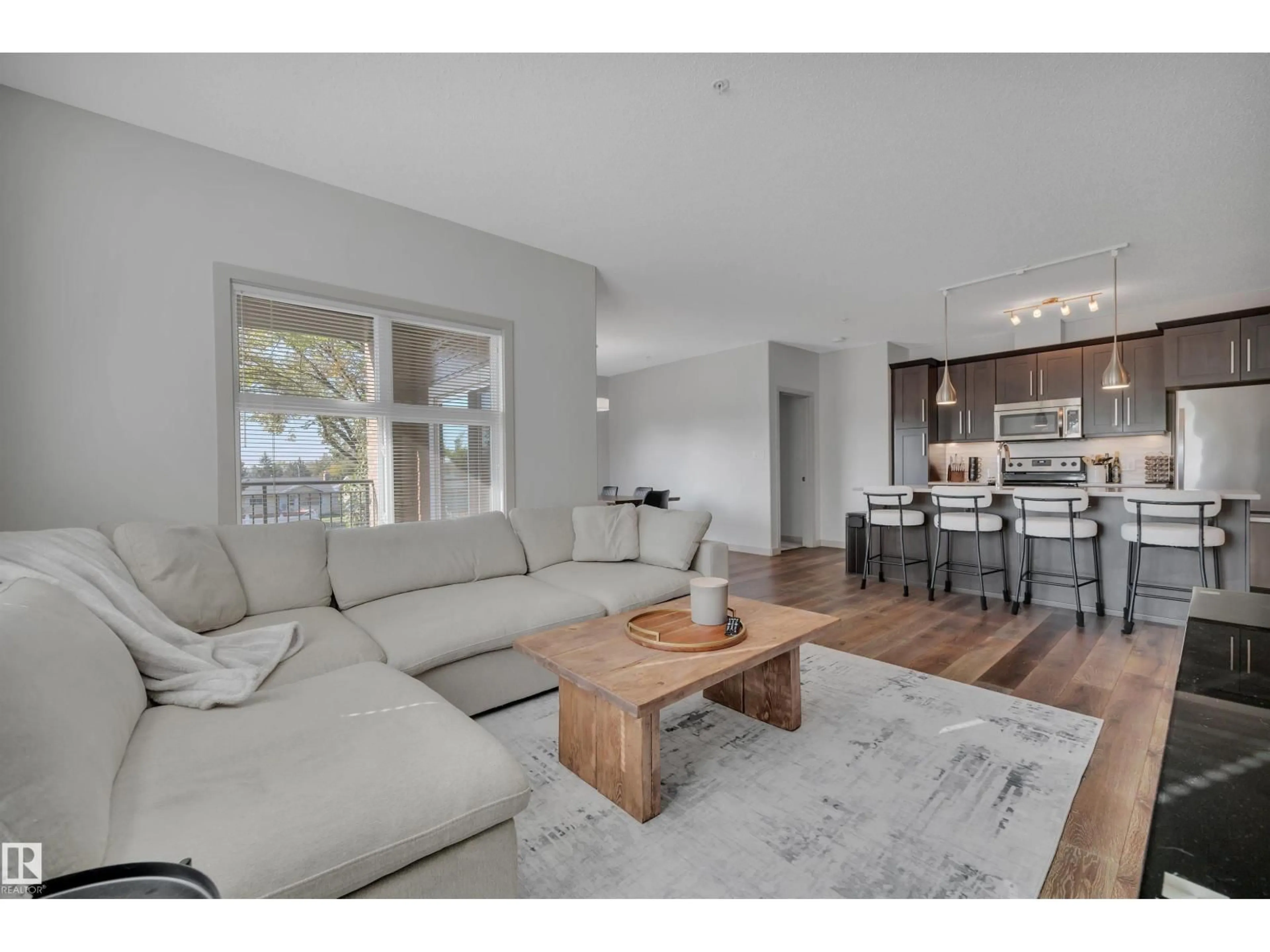 Living room with furniture, wood/laminate floor for #213 - 504 GRIESBACH PARADE, Edmonton Alberta T5E6V9