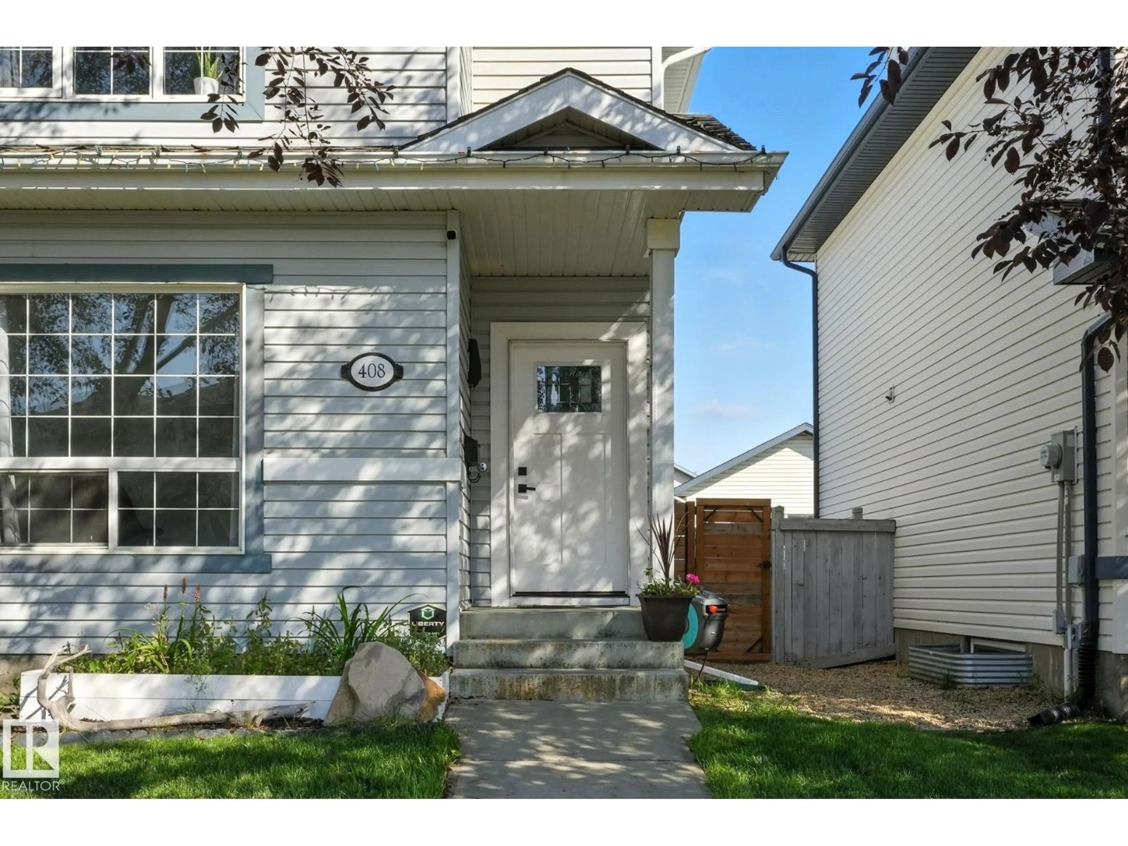 Home with vinyl exterior material, street for NW NW - 408 GIBB WD, Edmonton Alberta T5T6W8