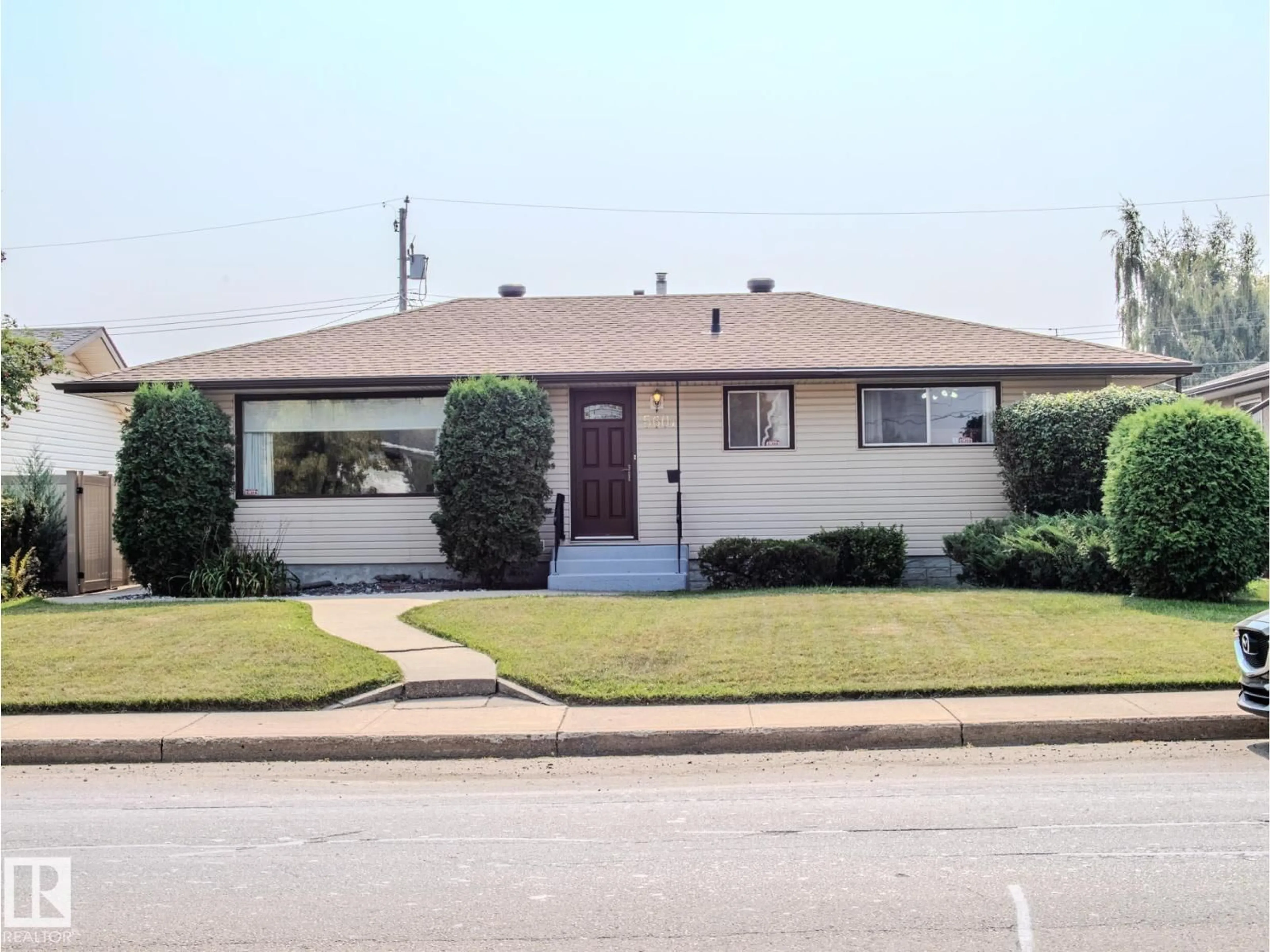 Home with vinyl exterior material, street for NW - 5607 94B AV, Edmonton Alberta T6B0Z1