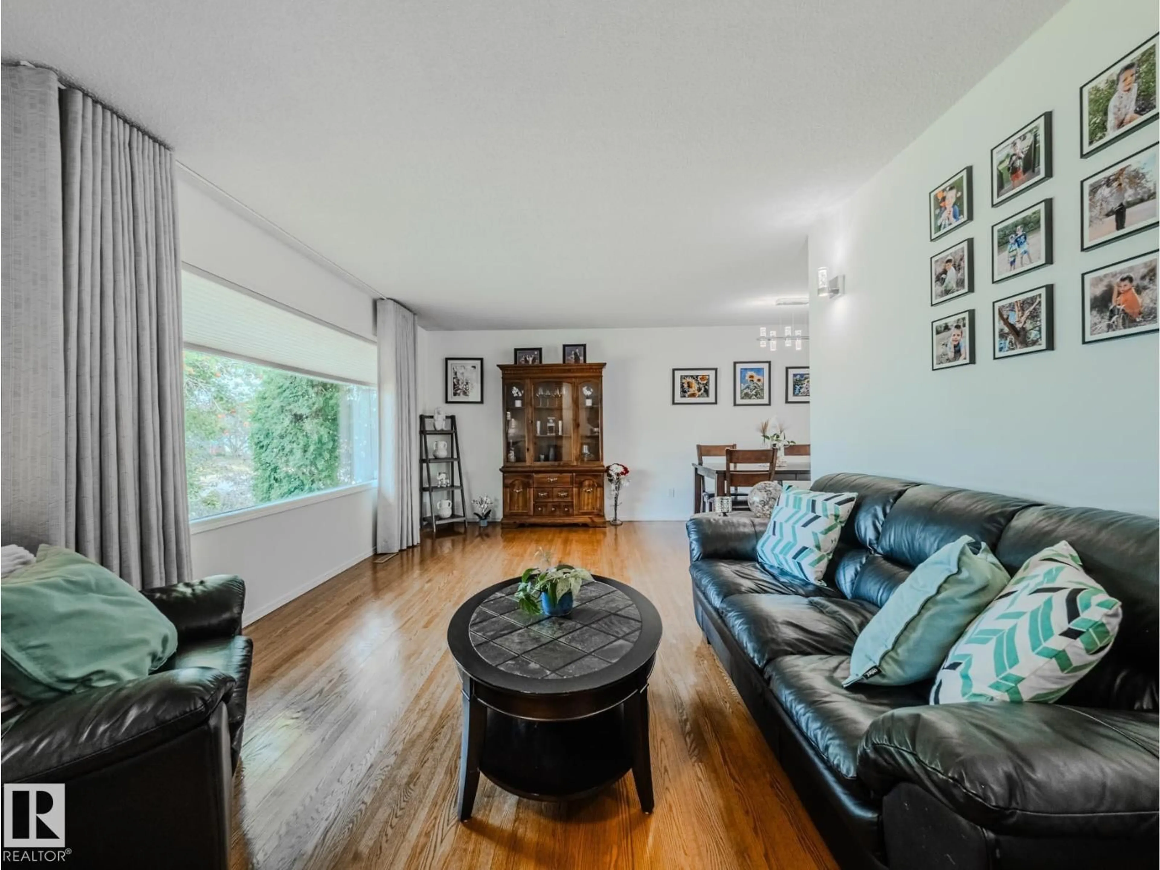 Living room with furniture, wood/laminate floor for NW - 5607 94B AV, Edmonton Alberta T6B0Z1