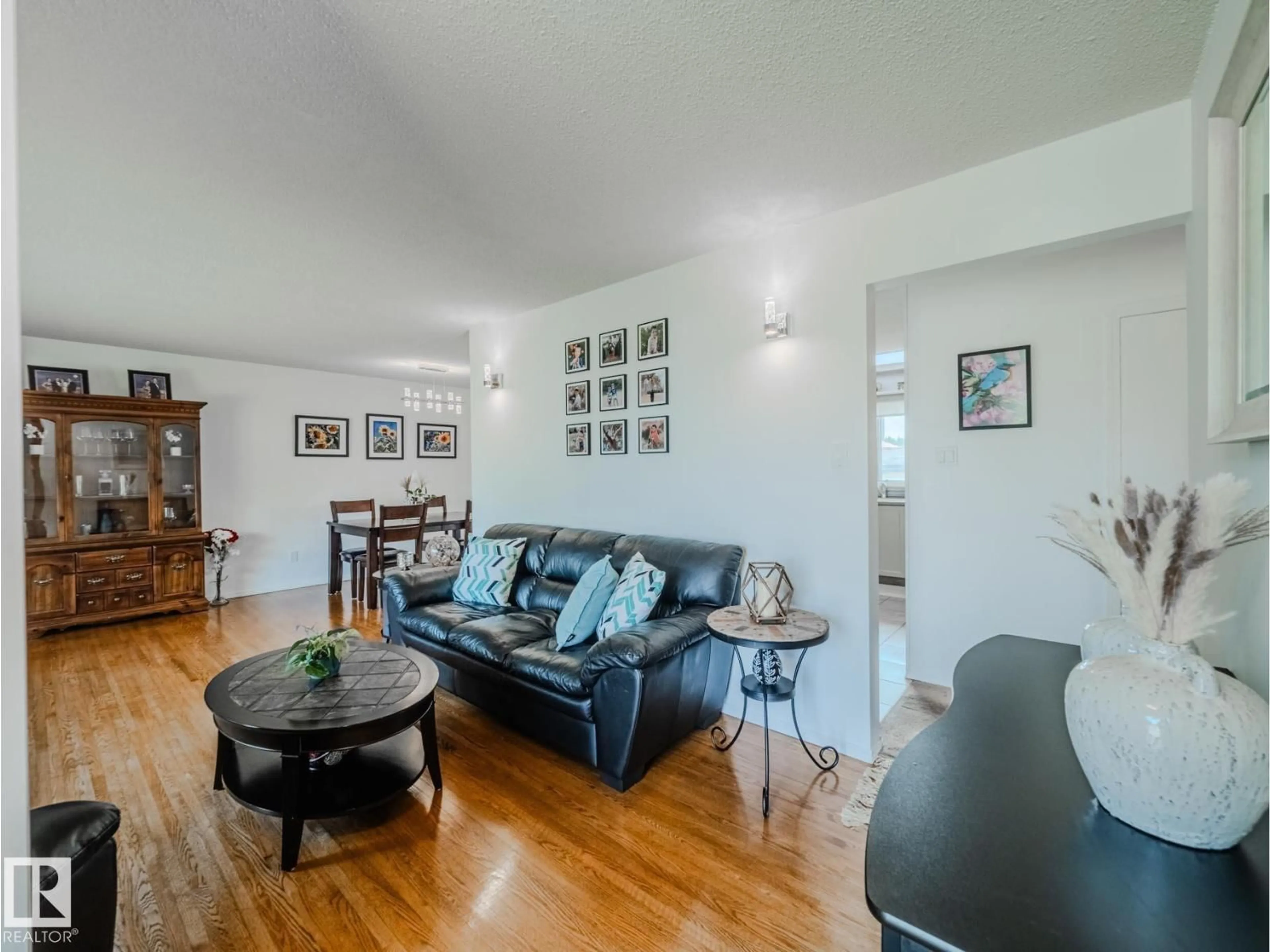 Living room with furniture, wood/laminate floor for NW - 5607 94B AV, Edmonton Alberta T6B0Z1