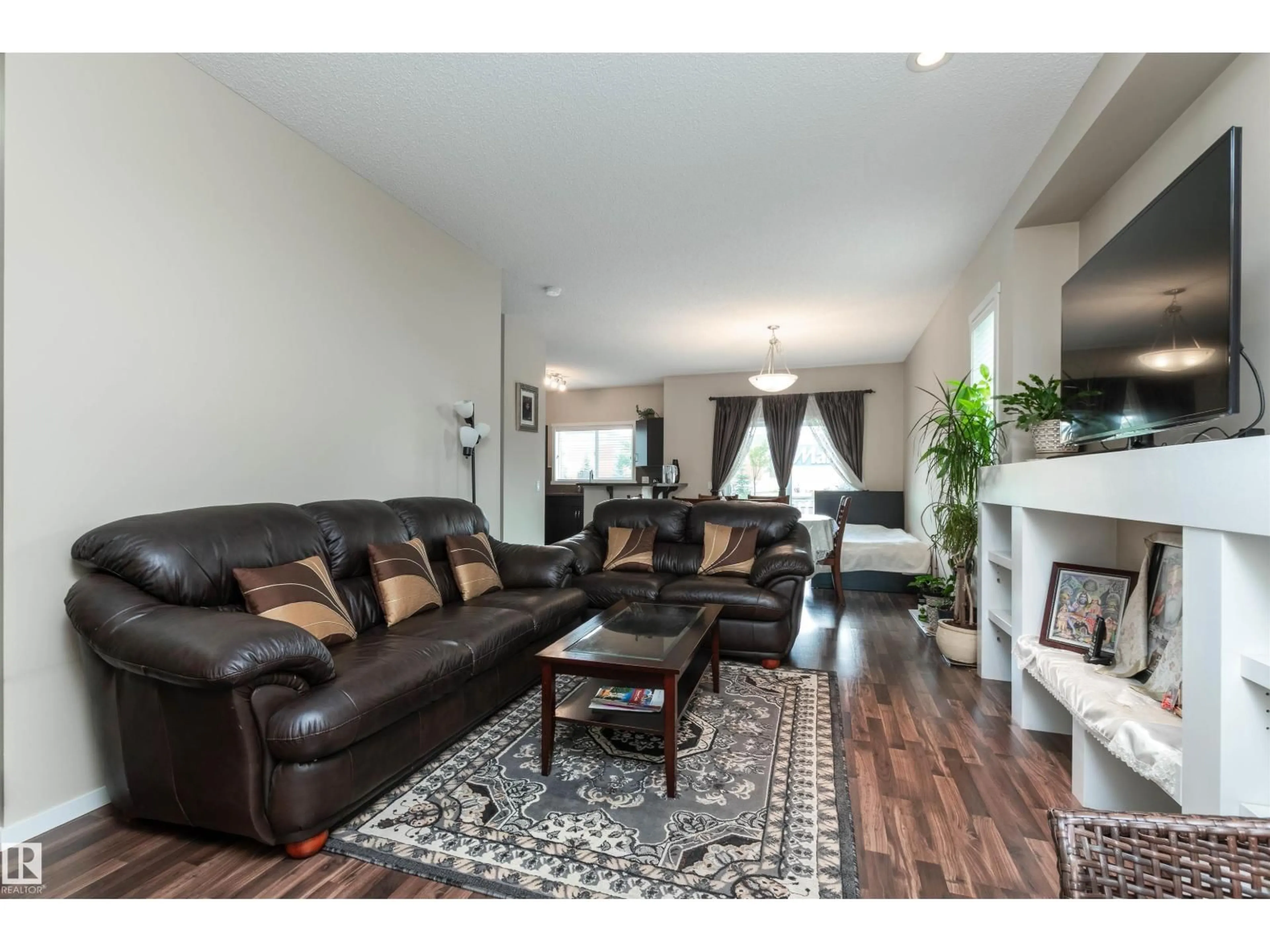 Living room with furniture, wood/laminate floor for 7526 ELLESMERE WY, Sherwood Park Alberta T8H0P6