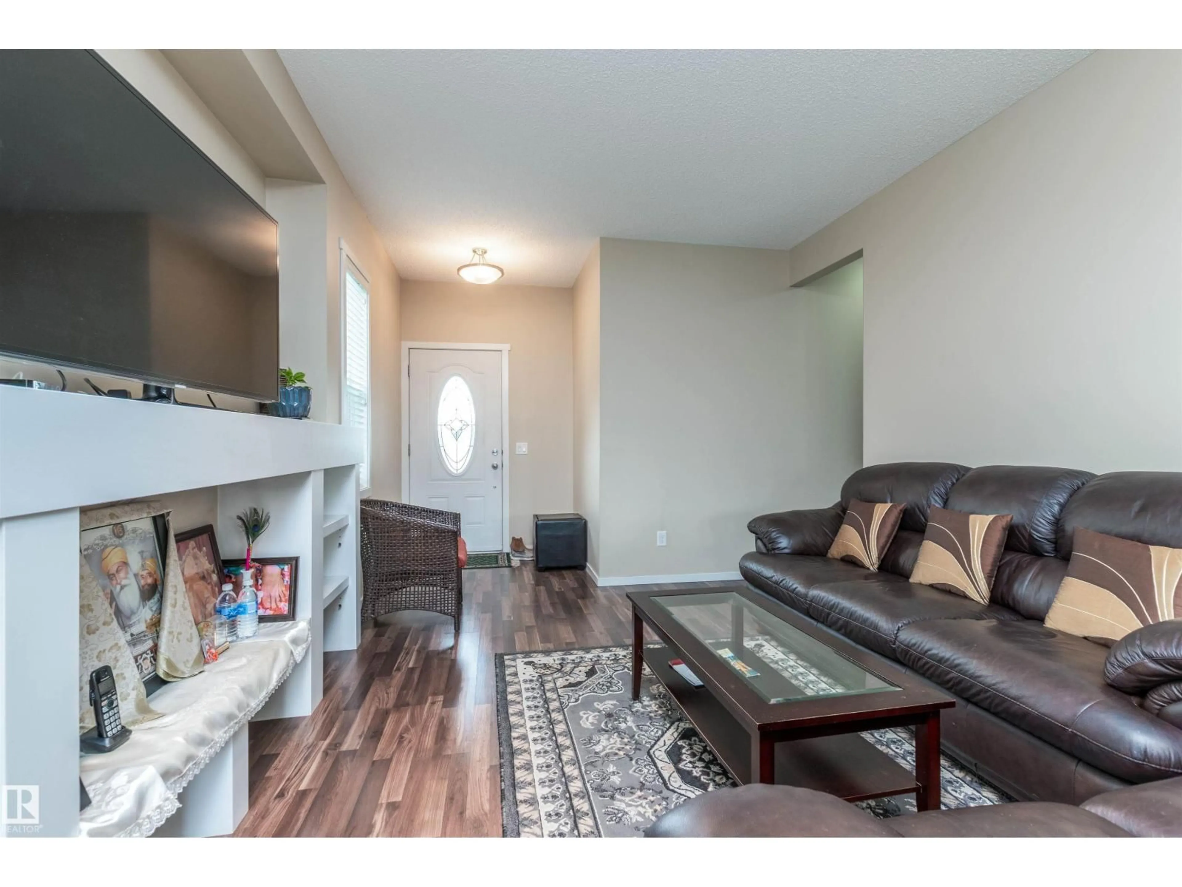 Living room with furniture, wood/laminate floor for 7526 ELLESMERE WY, Sherwood Park Alberta T8H0P6