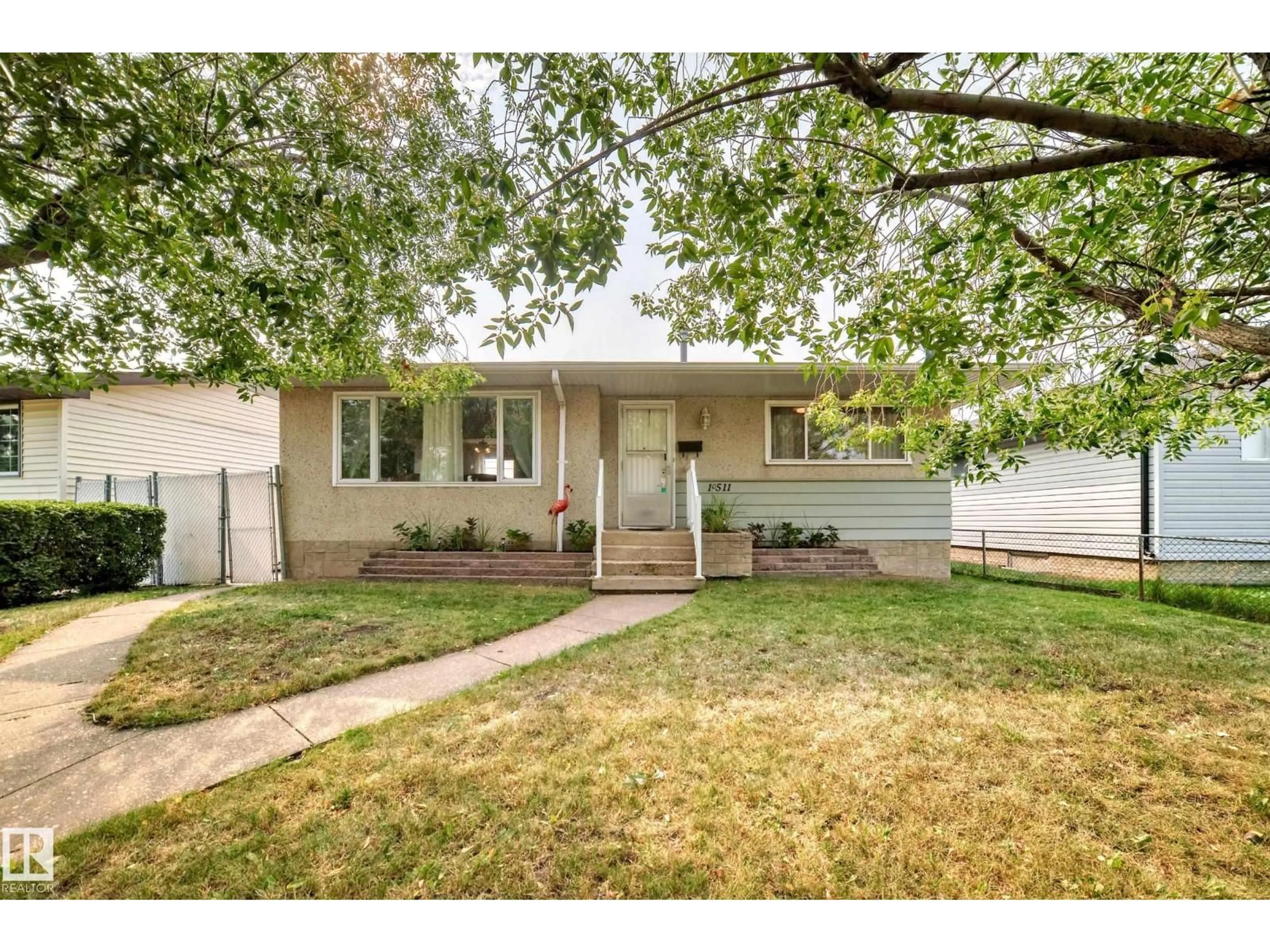 Home with vinyl exterior material, street for NW - 10511 135B AV, Edmonton Alberta T5E1T7