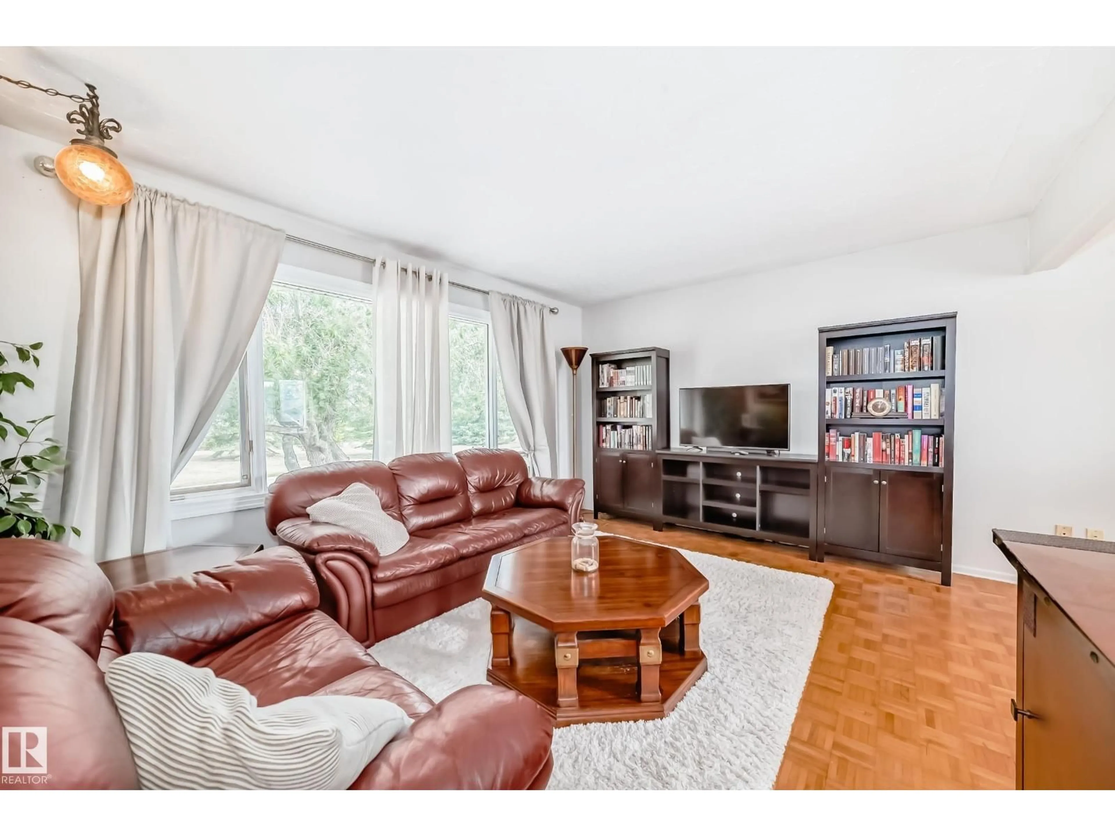 Living room with furniture, wood/laminate floor for NW - 10511 135B AV, Edmonton Alberta T5E1T7