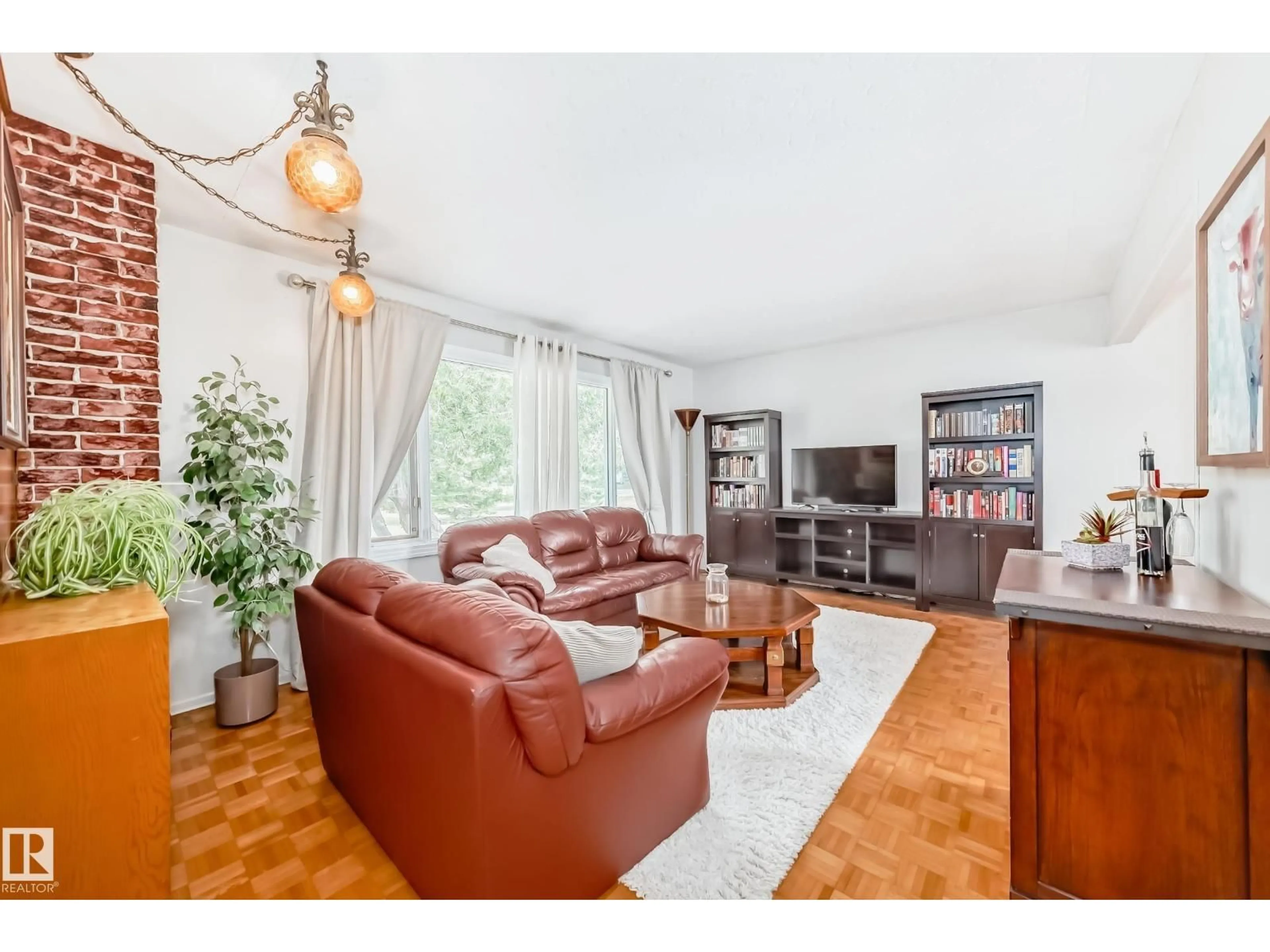 Living room with furniture, wood/laminate floor for NW - 10511 135B AV, Edmonton Alberta T5E1T7