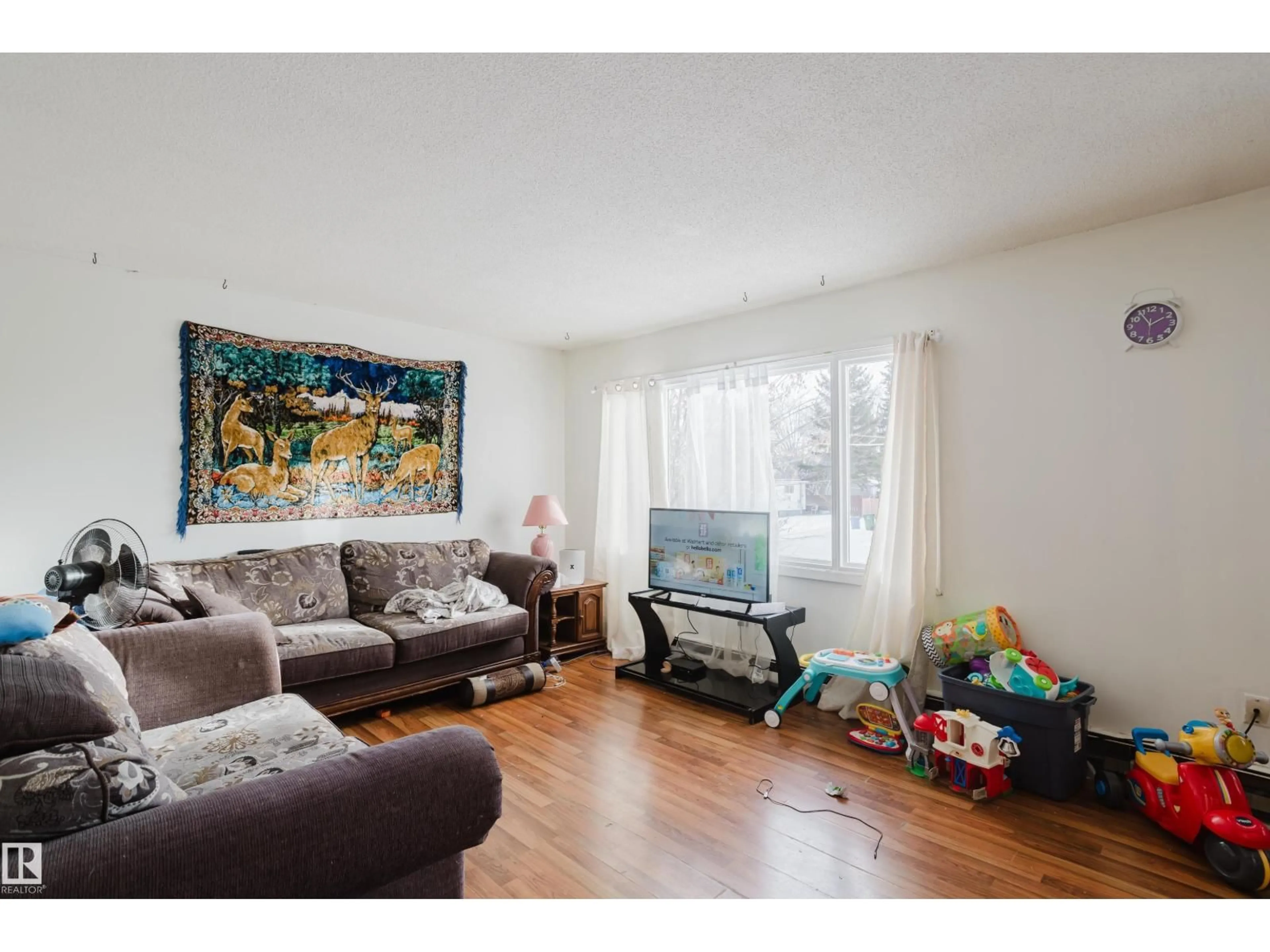 Living room with furniture, wood/laminate floor for 4501 47 ST, Wetaskiwin Alberta T9A1C3
