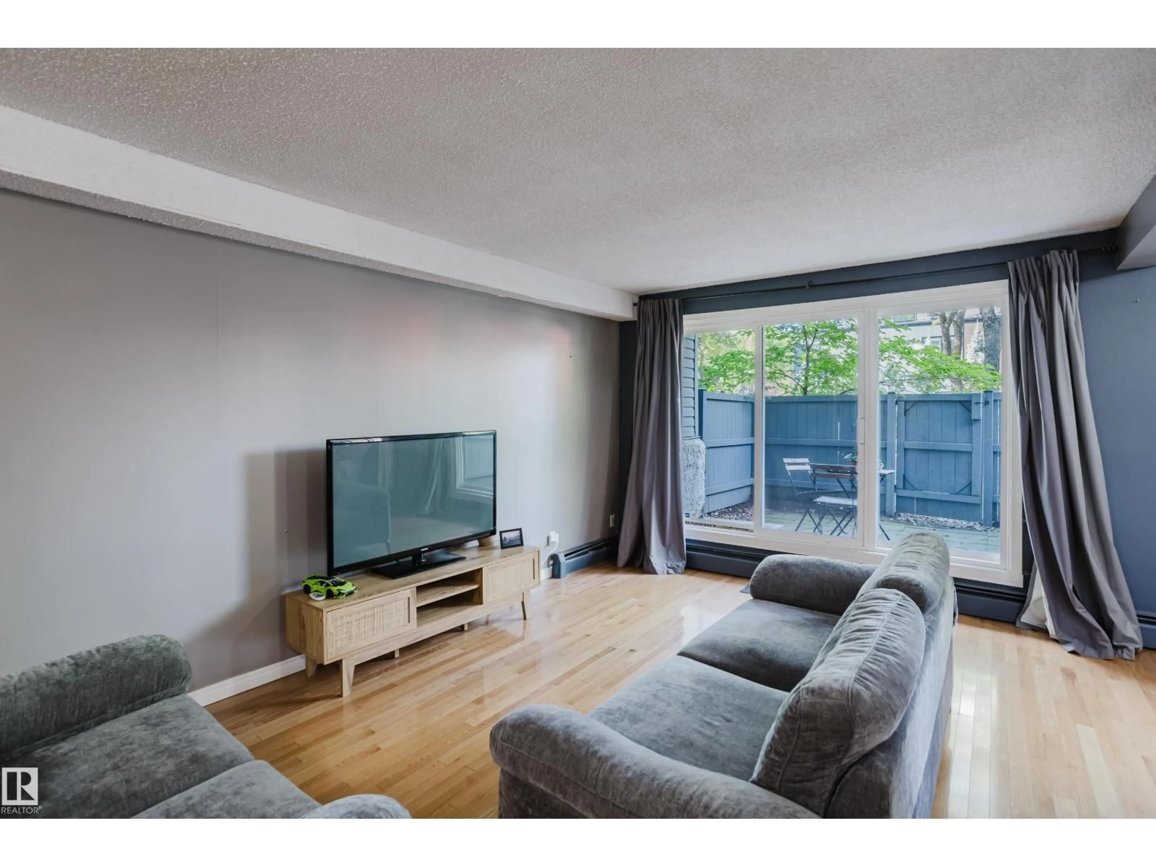 Living room with furniture, wood/laminate floor for 106 - 11217 103 AV NW, Edmonton Alberta T5K2V9