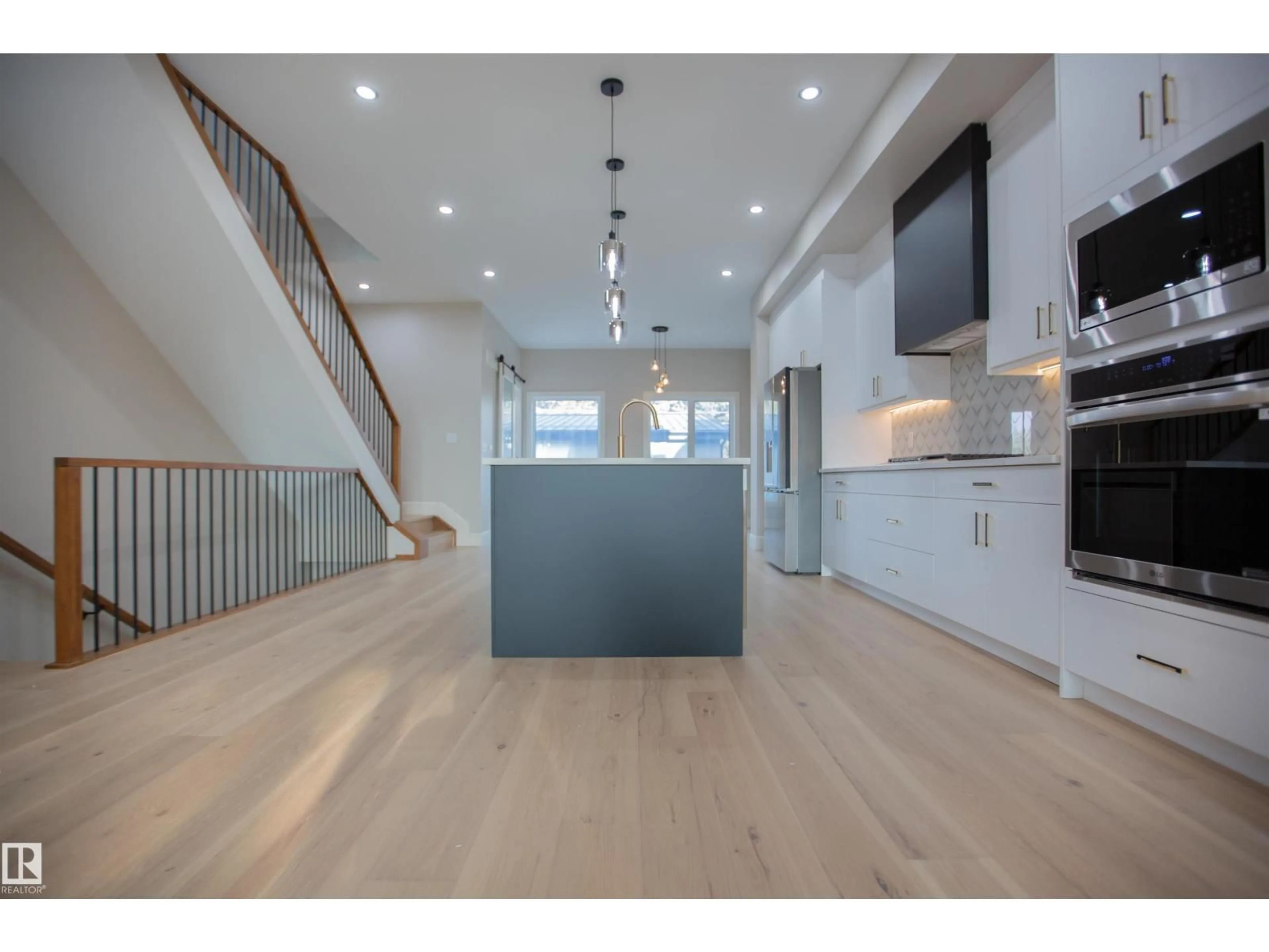 Open concept kitchen, wood/laminate floor for 9127 143 ST, Edmonton Alberta T5R0P5