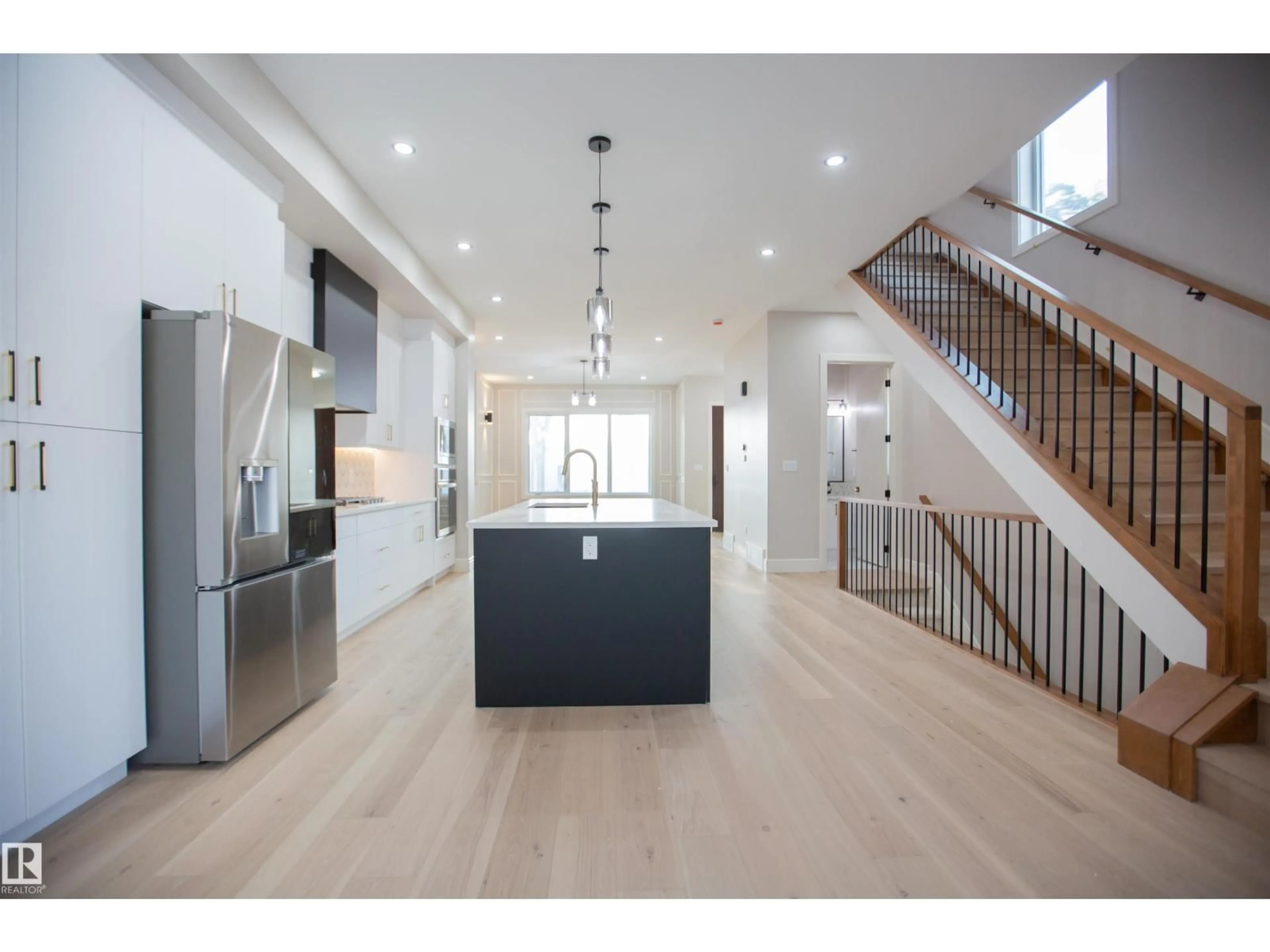 Open concept kitchen, wood/laminate floor for 9127 143 ST, Edmonton Alberta T5R0P5