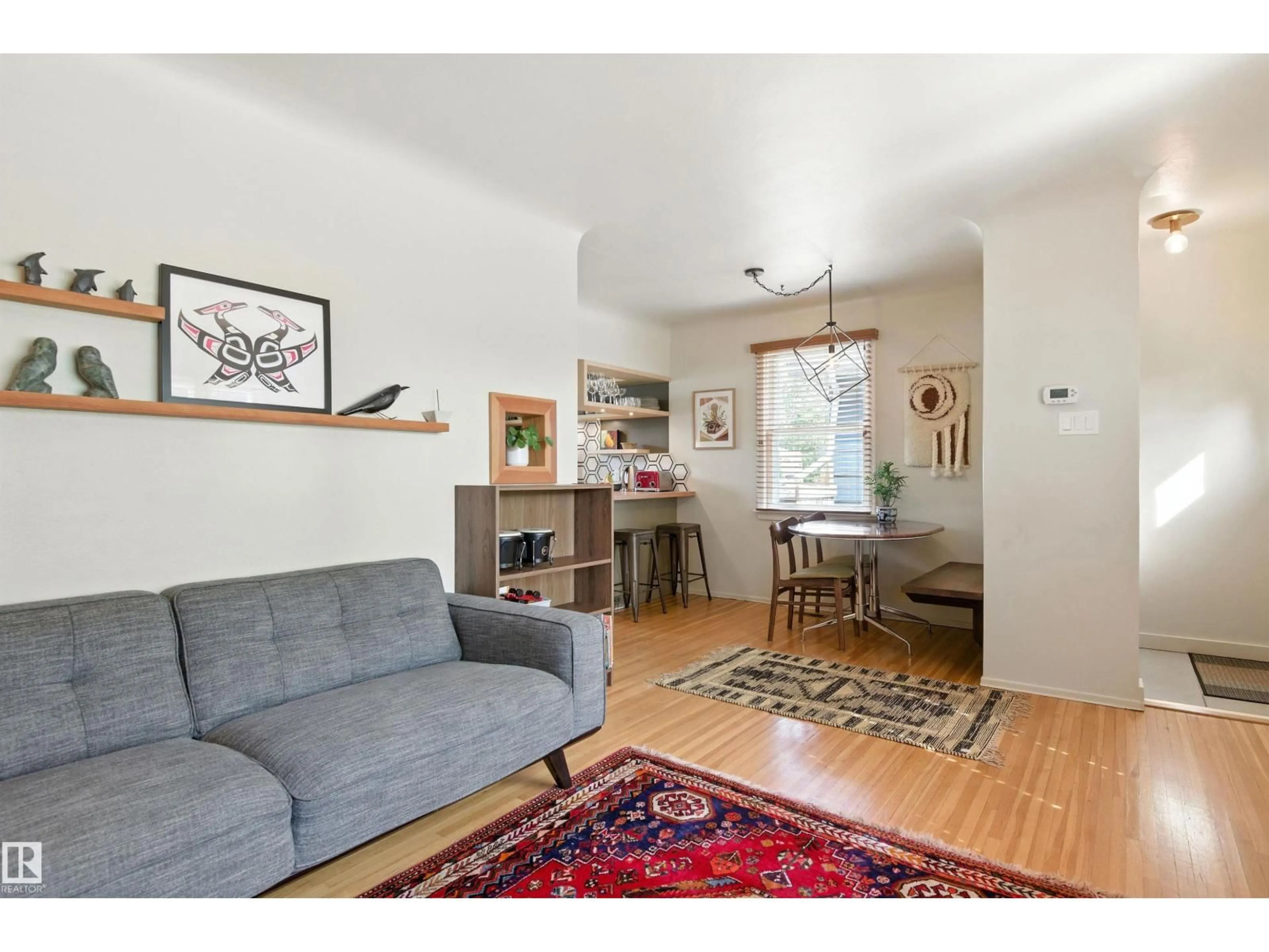 Living room with furniture, wood/laminate floor for 7744 86 AV, Edmonton Alberta T6C1H8