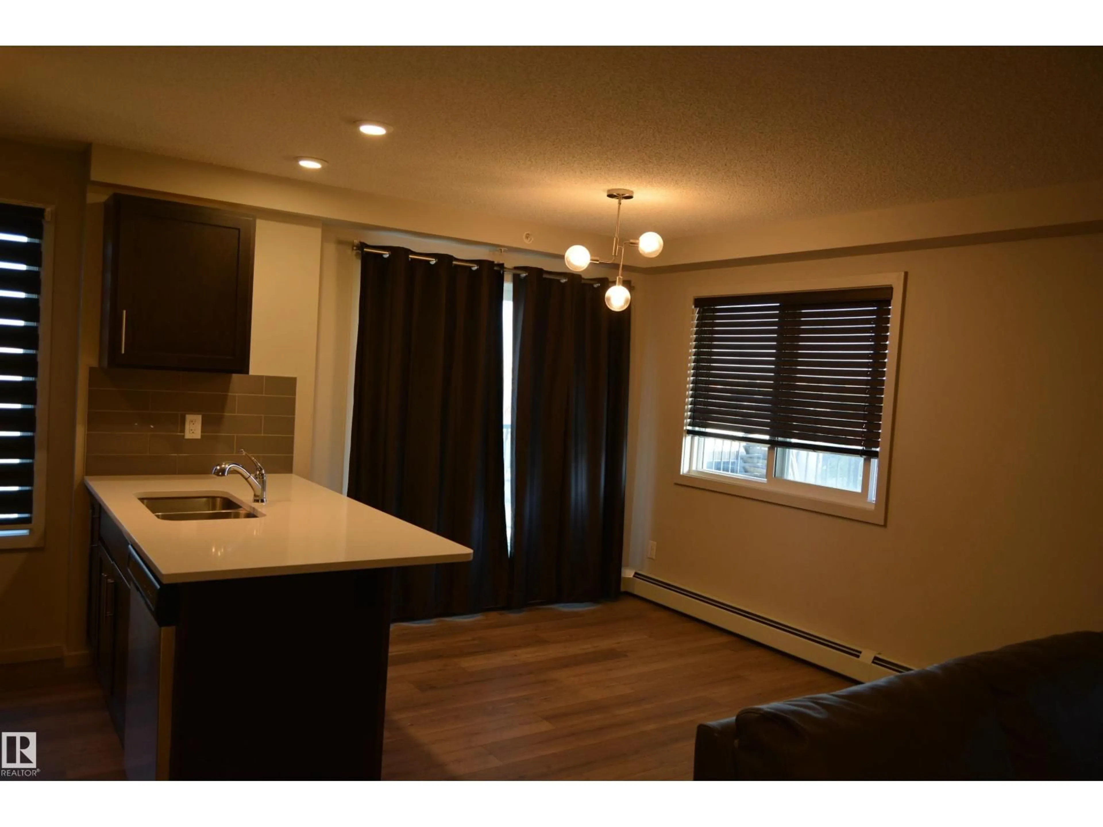Open concept kitchen, wood/laminate floor for #408 - 5404 7 AV SW, Edmonton Alberta T6X2K4