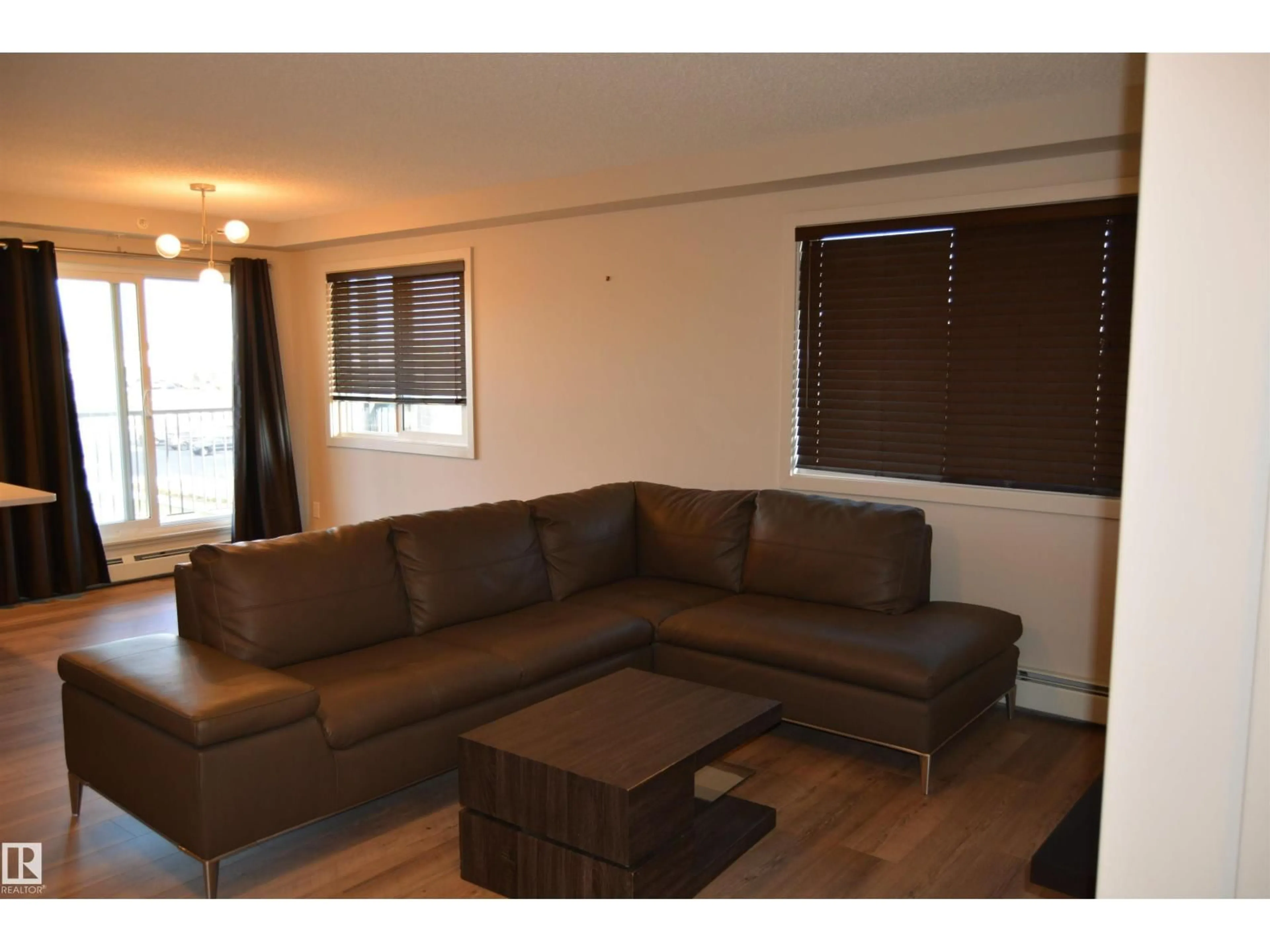 Living room with furniture, wood/laminate floor for #408 - 5404 7 AV SW, Edmonton Alberta T6X2K4