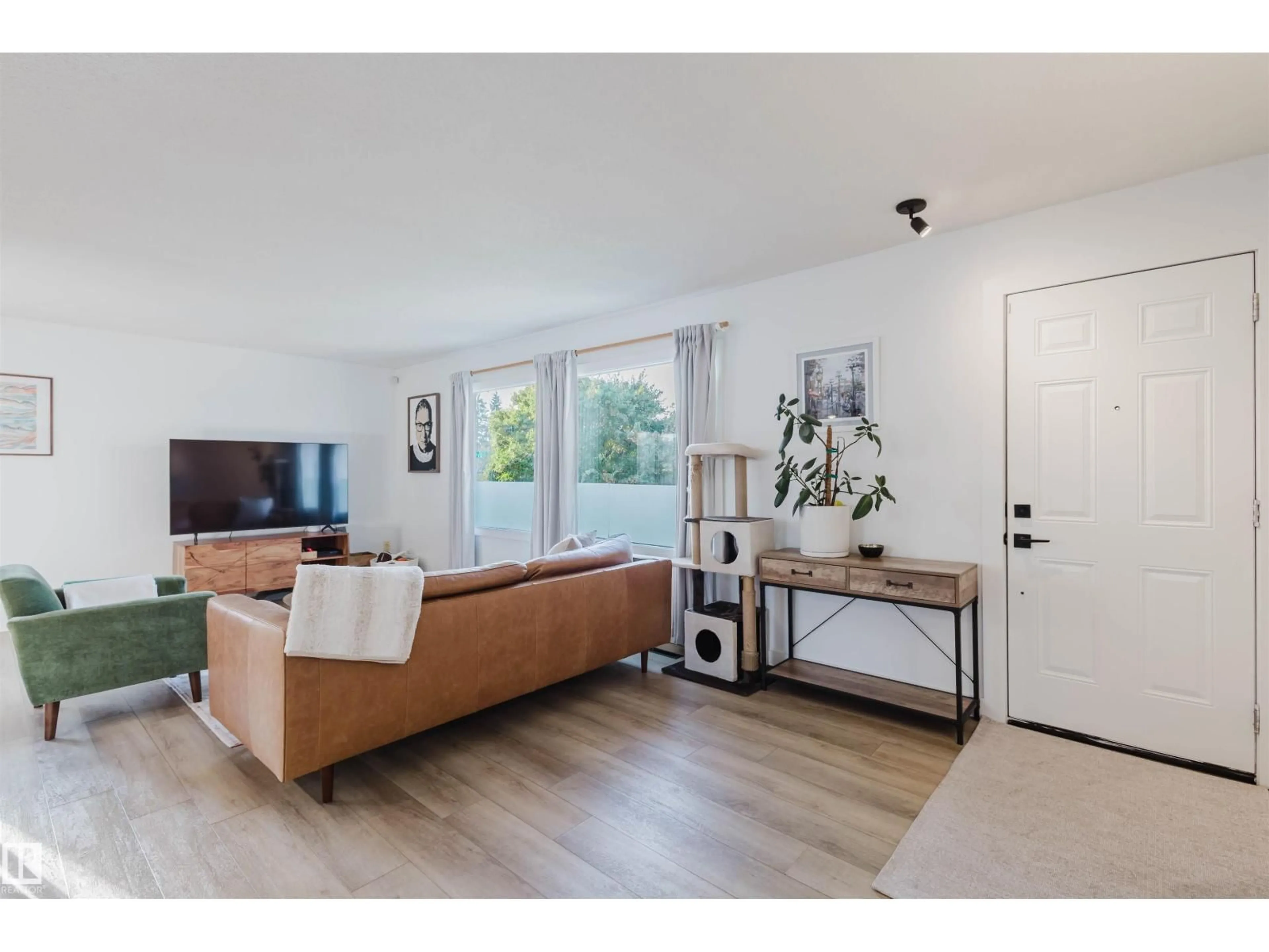 Living room with furniture, wood/laminate floor for 11215 41 AV, Edmonton Alberta T6J0T6