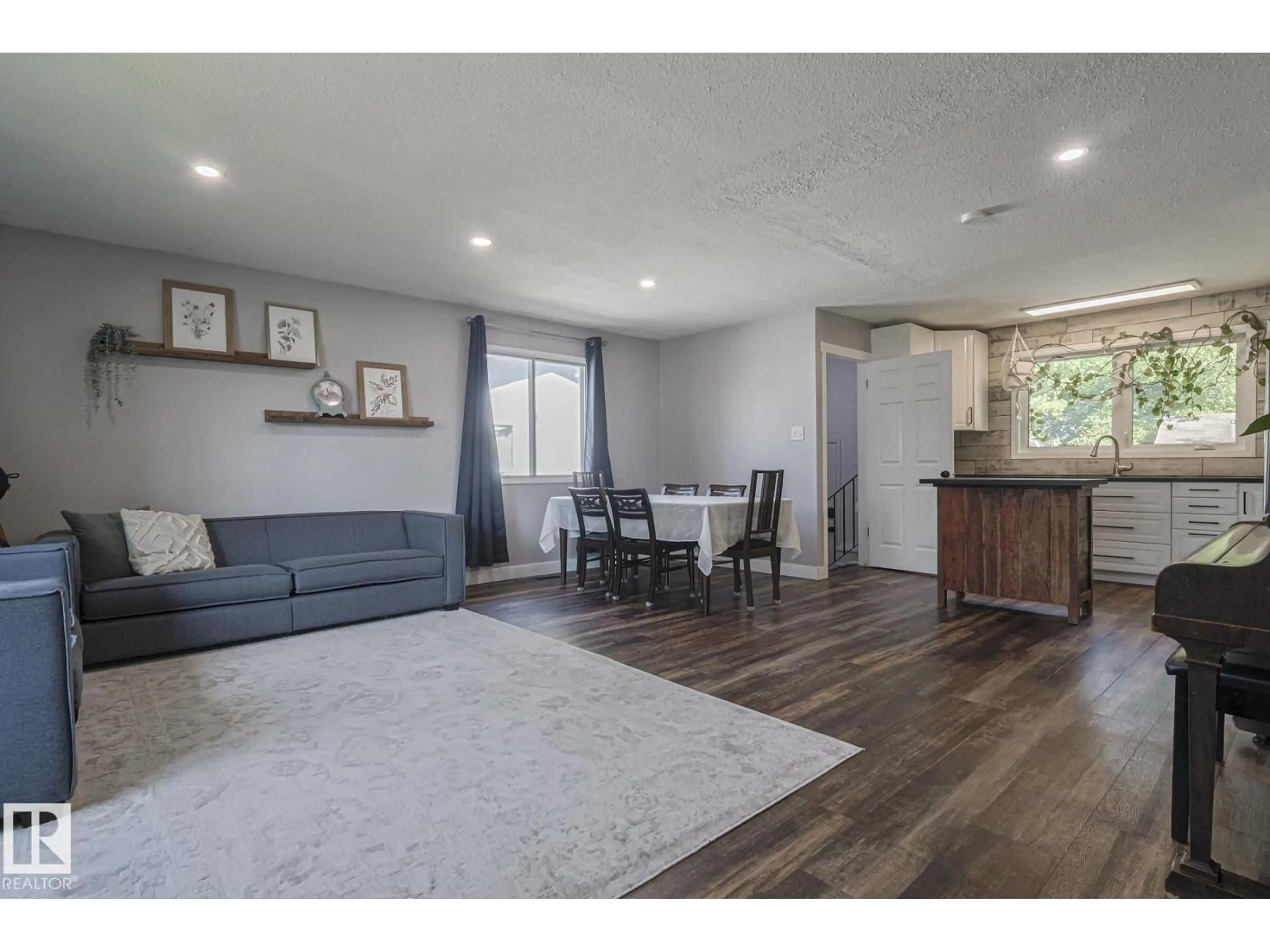 Living room with furniture, wood/laminate floor for 3135 74 ST, Edmonton Alberta T6K1J7