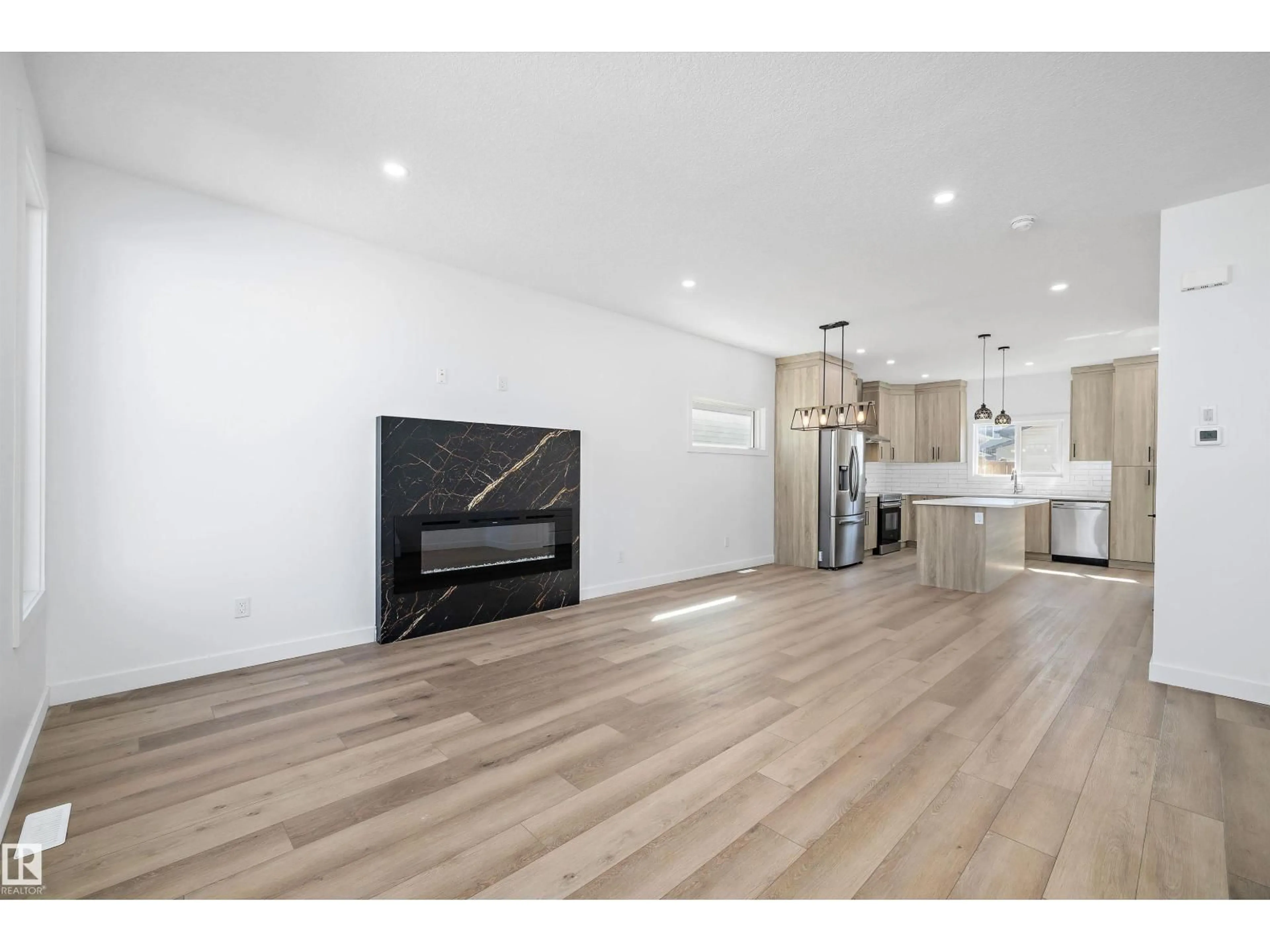 Open concept kitchen, wood/laminate floor for NW - 6079 180 AV, Edmonton Alberta T5Y3X1