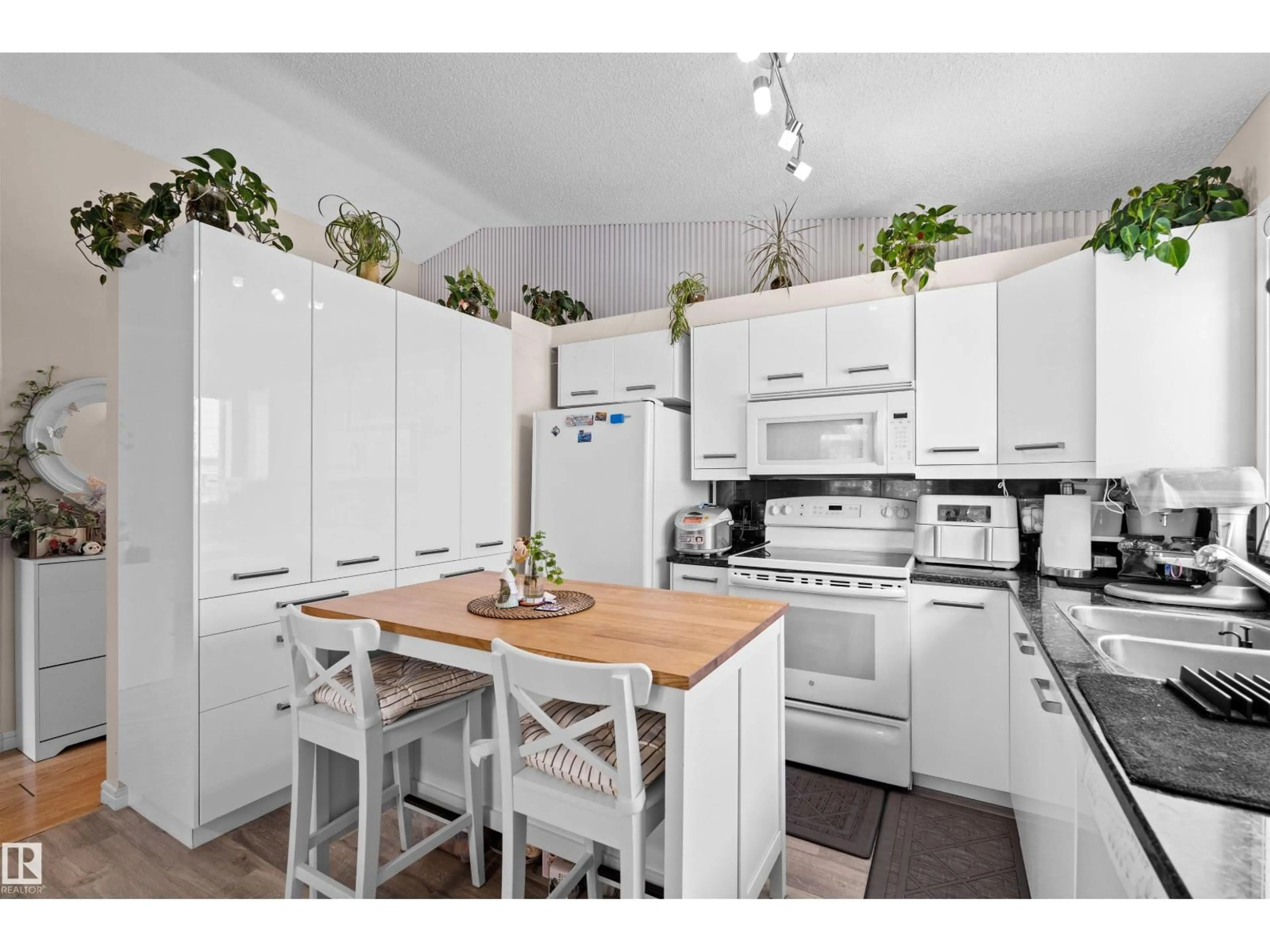 Open concept kitchen, wood/laminate floor for 333 DECHENE WY, Edmonton Alberta T6M2M6