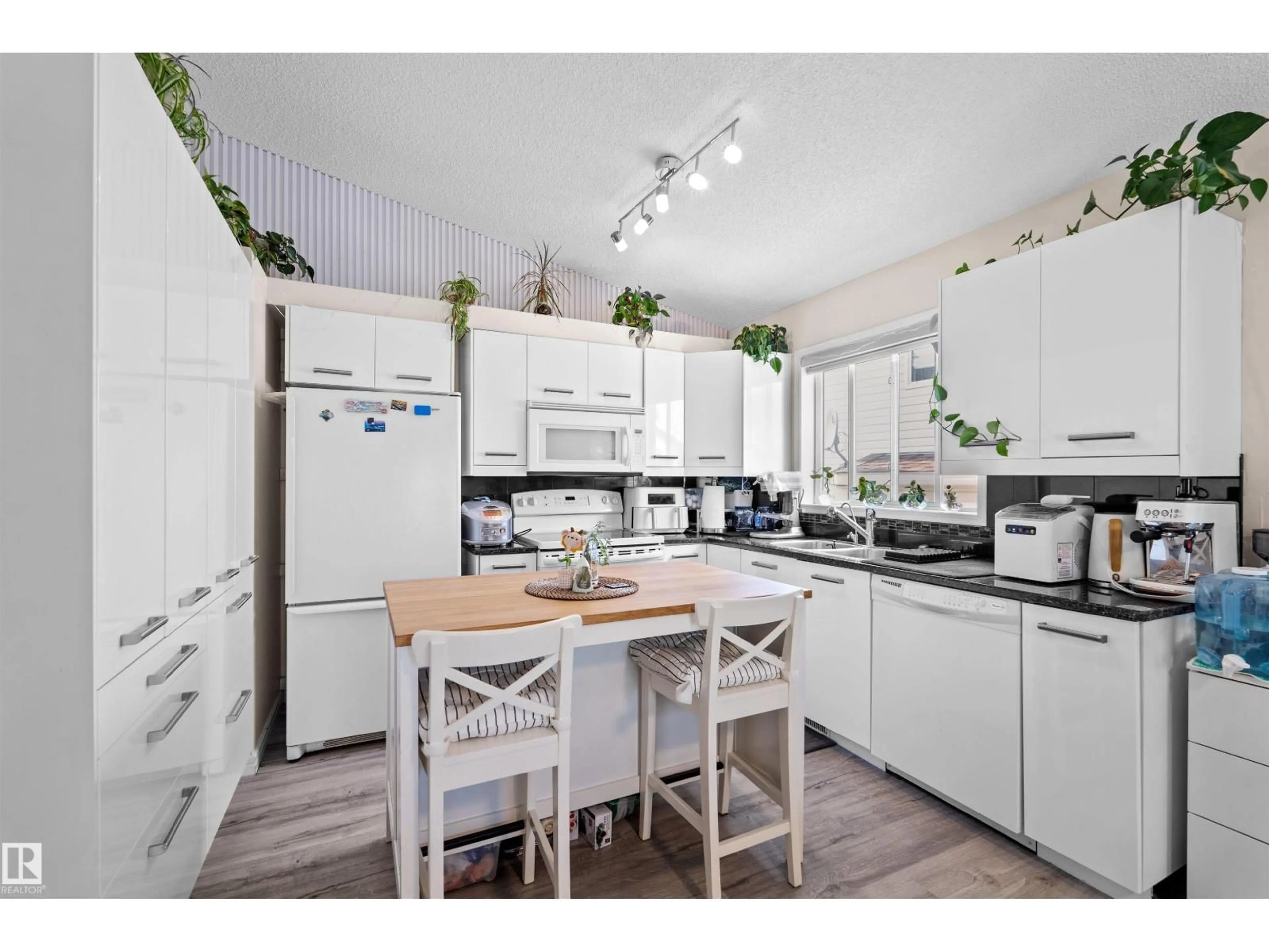 Open concept kitchen, wood/laminate floor for 333 DECHENE WY, Edmonton Alberta T6M2M6
