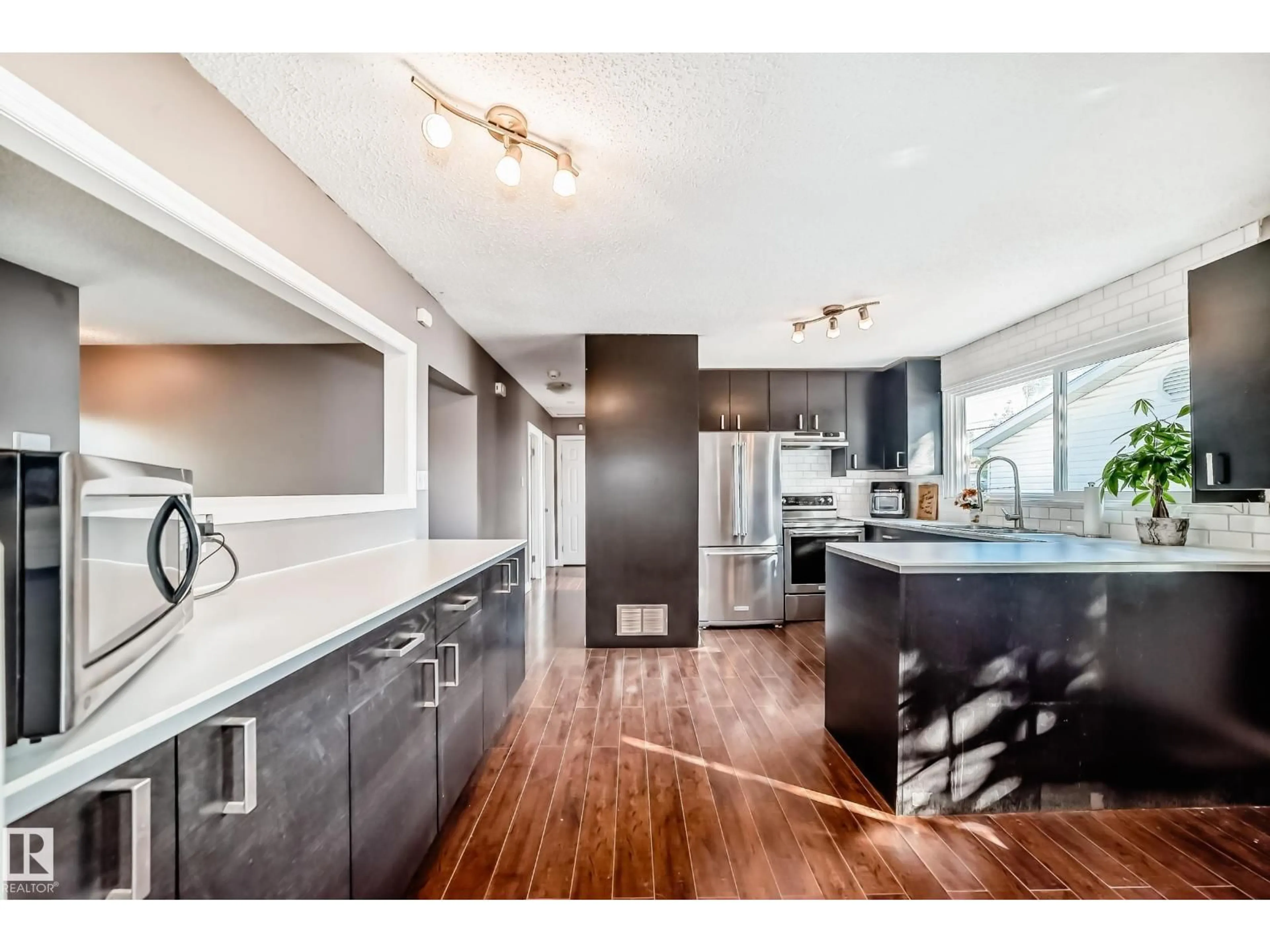 Open concept kitchen, wood/laminate floor for NW - 13415 109 ST, Edmonton Alberta T5E4Y6