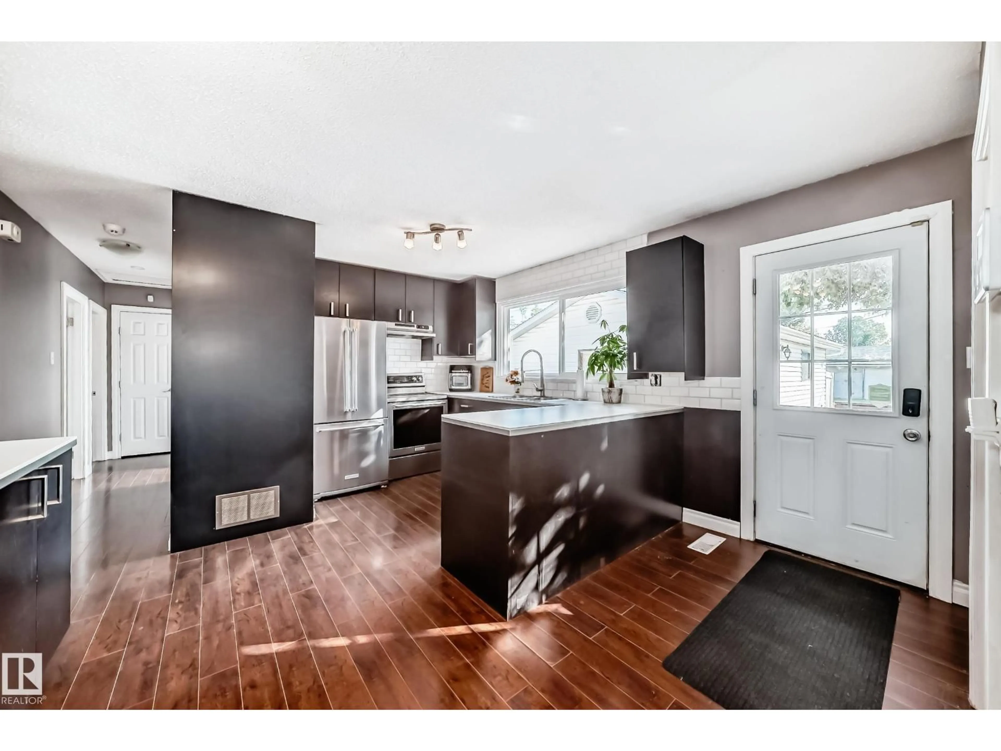 Open concept kitchen, wood/laminate floor for NW - 13415 109 ST, Edmonton Alberta T5E4Y6