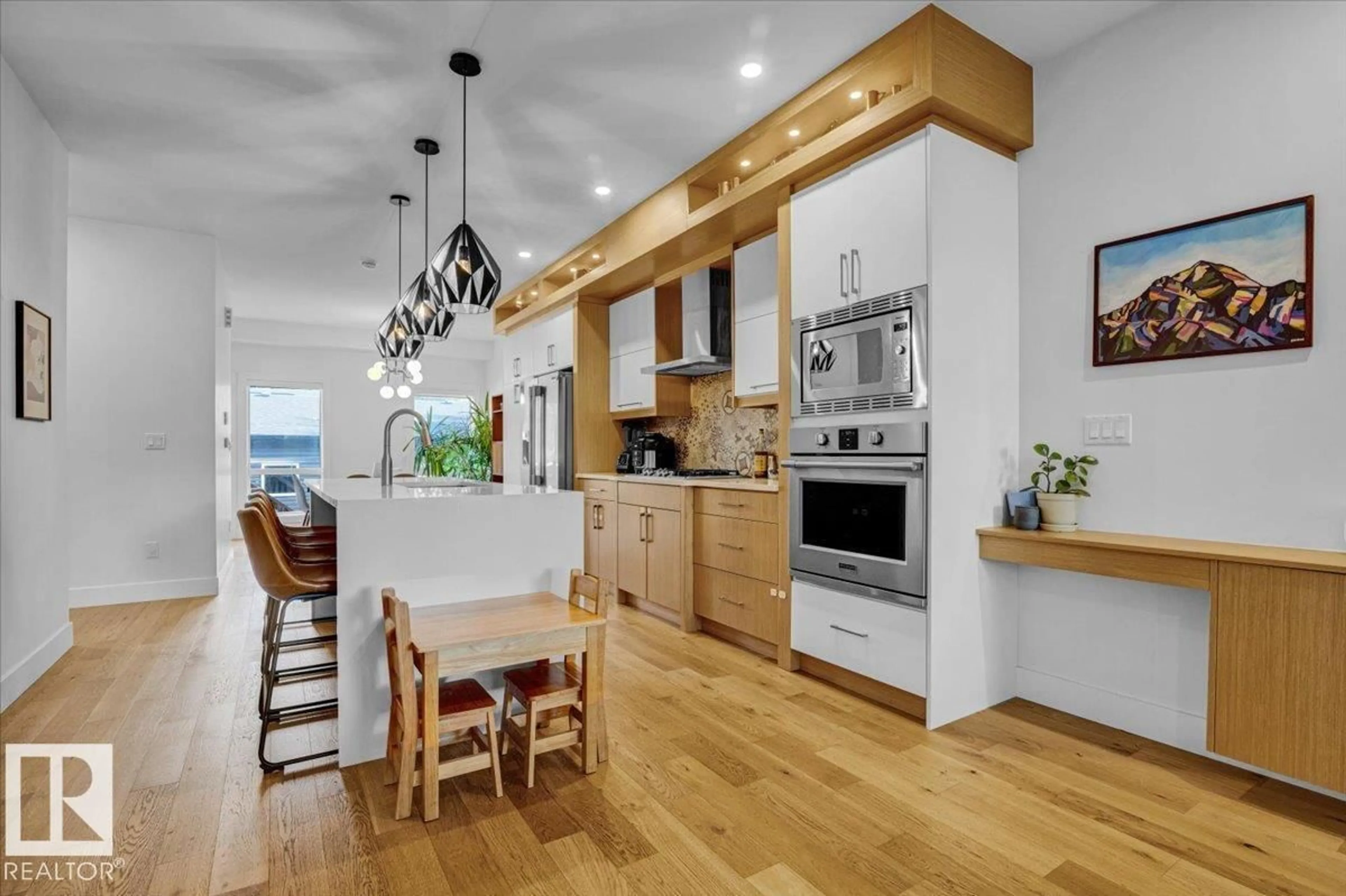 Open concept kitchen, wood/laminate floor for 7736 80 AV, Edmonton Alberta T6C0S4