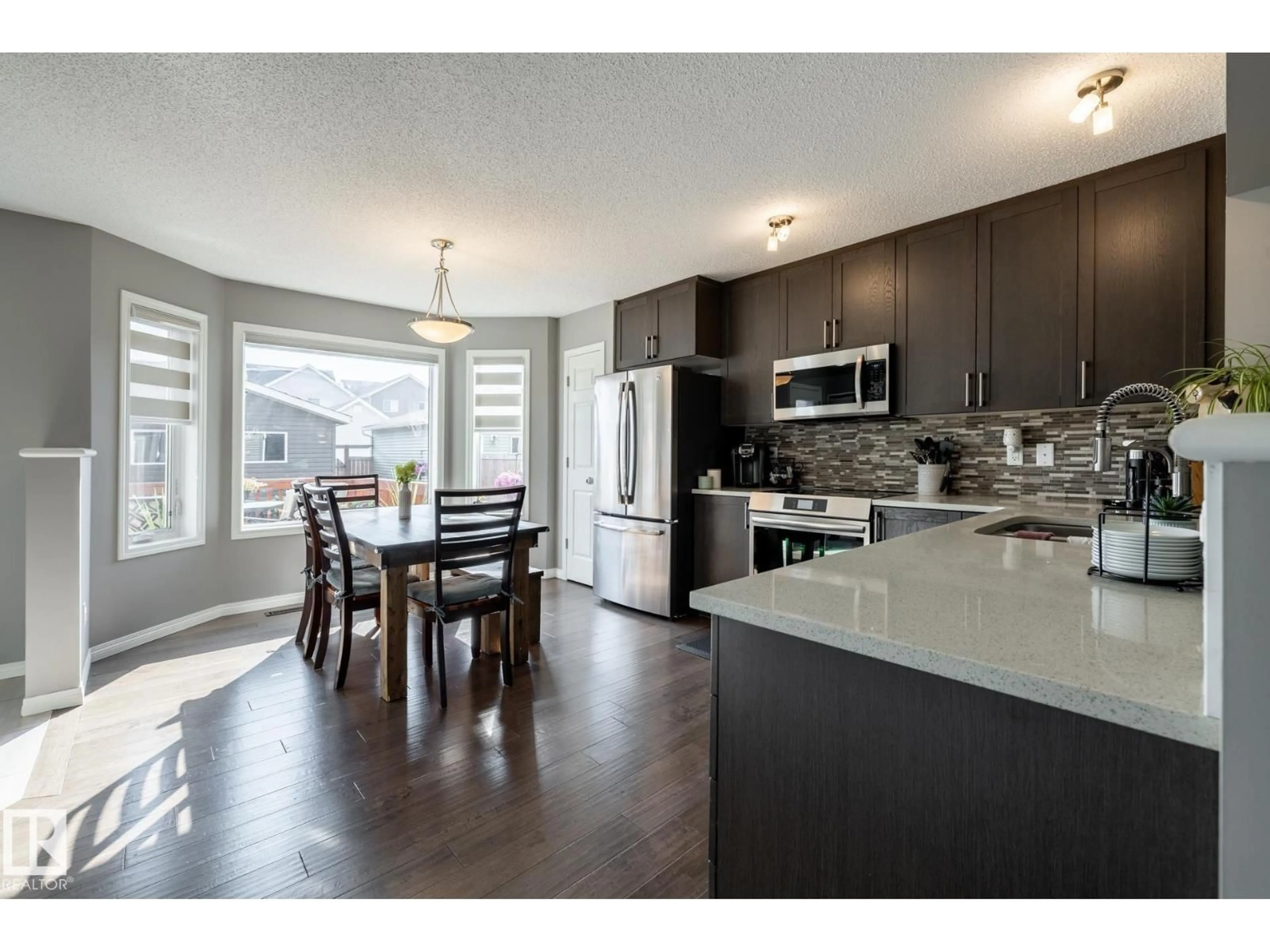 Open concept kitchen, wood/laminate floor for SW - 2339 83 ST, Edmonton Alberta T6X2G8