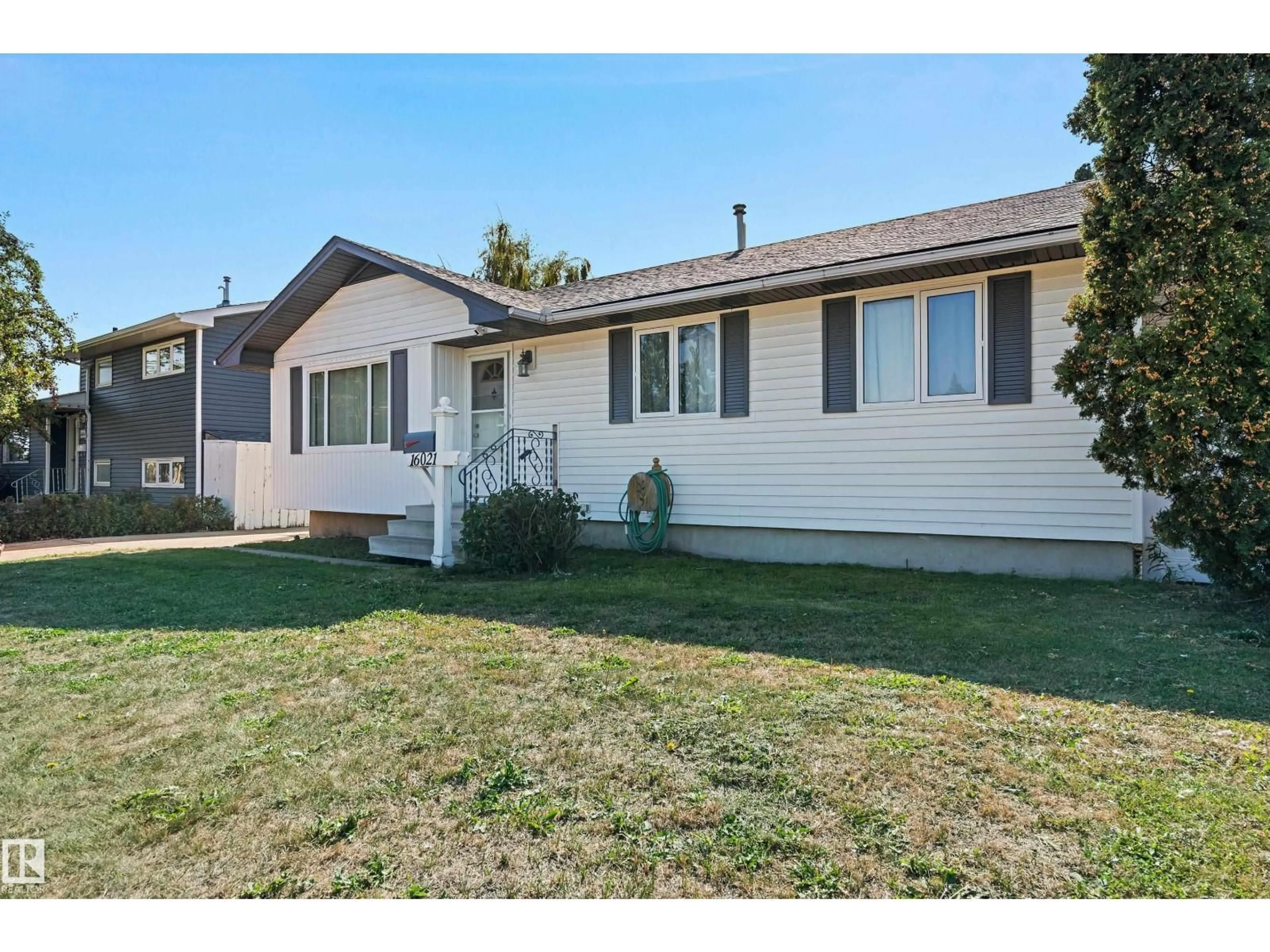 Home with vinyl exterior material, street for 16021 95 AV, Edmonton Alberta T5P0A8