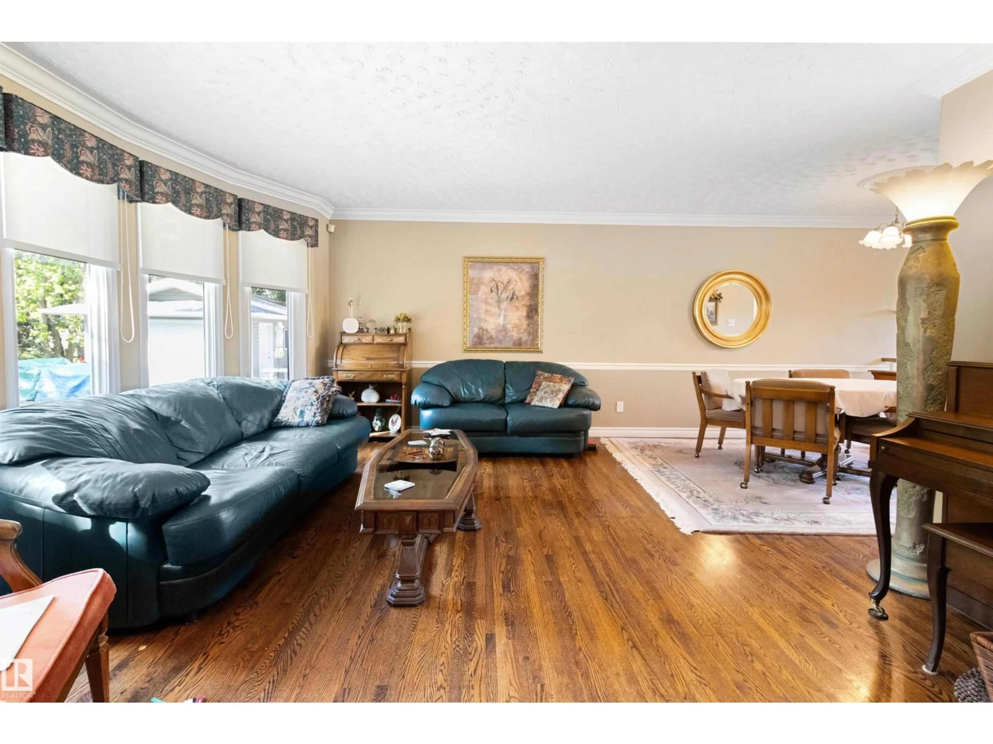 Living room with furniture, wood/laminate floor for 12 51514 RGE ROAD 261, Rural Parkland County Alberta T7Y1B3