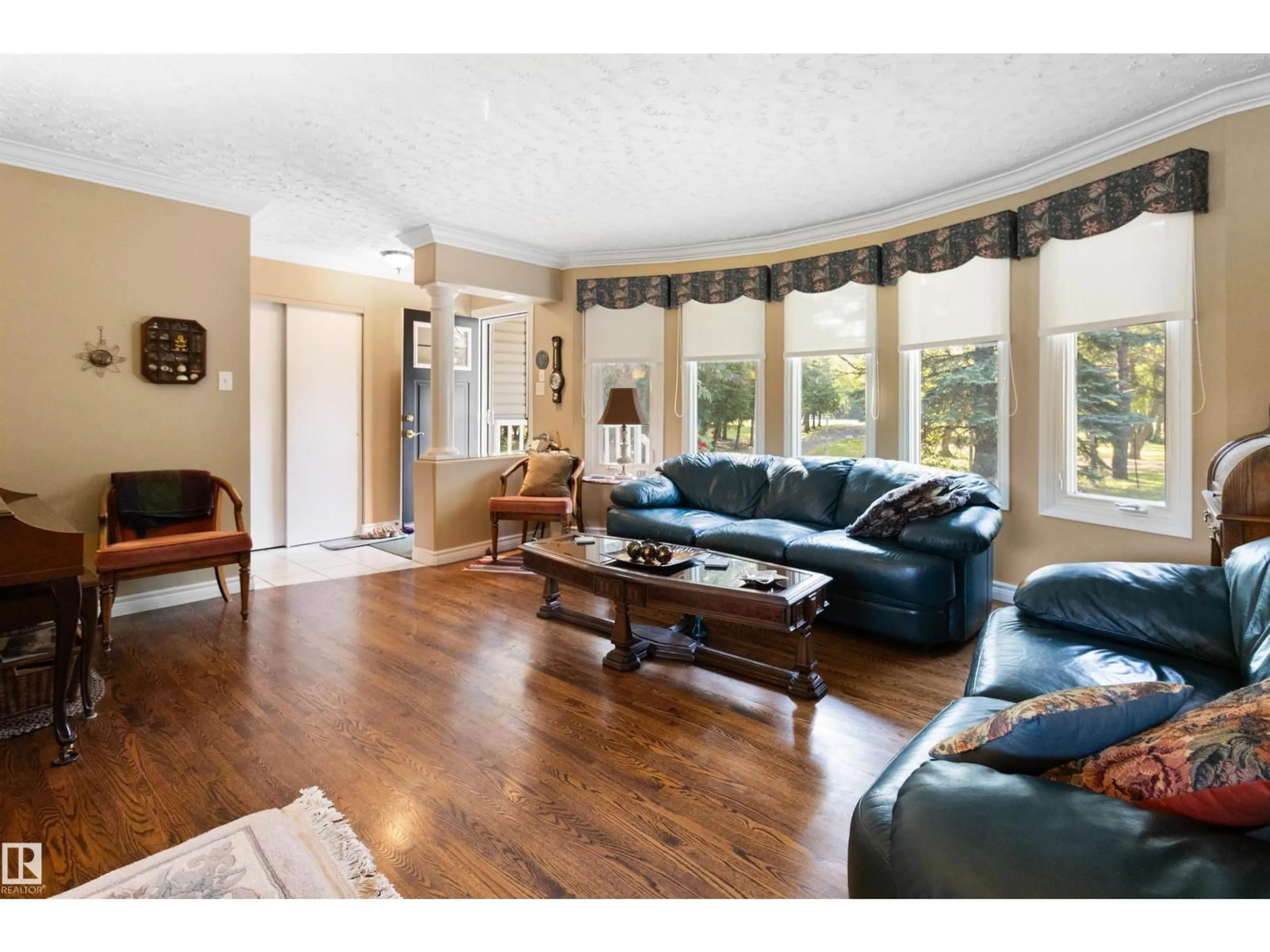 Living room with furniture, wood/laminate floor for 12 51514 RGE ROAD 261, Rural Parkland County Alberta T7Y1B3