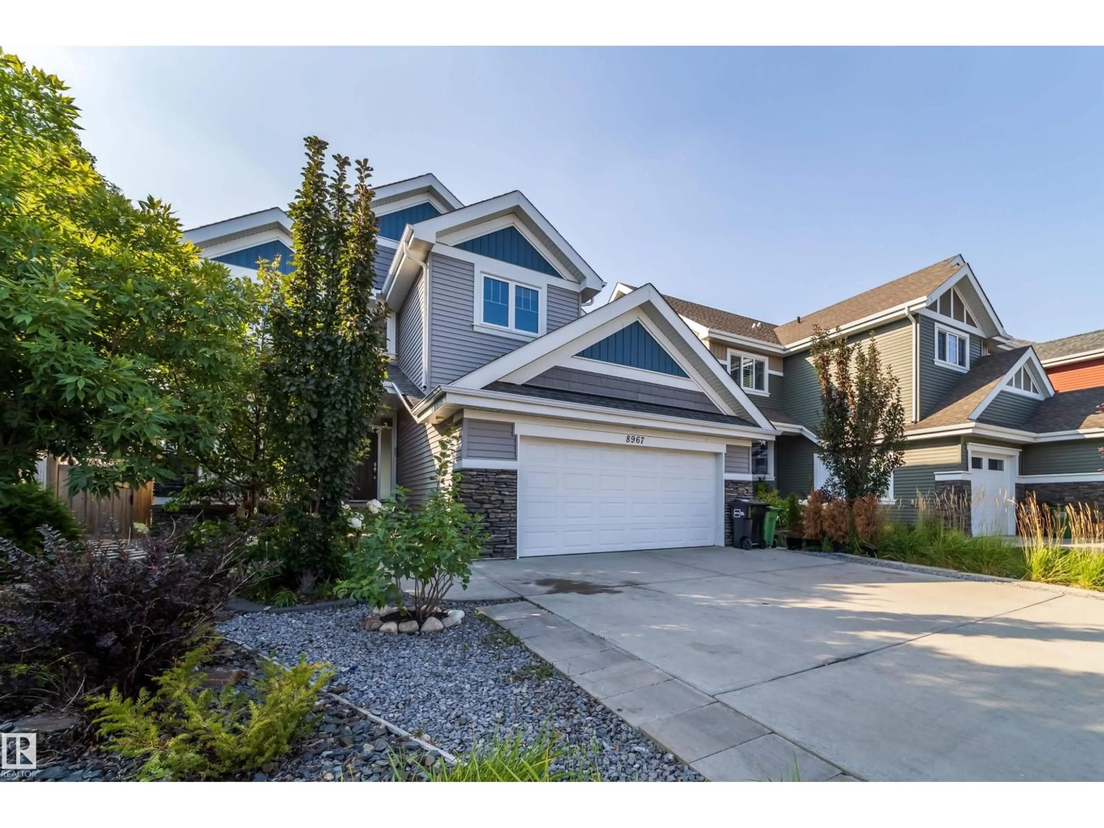 Home with vinyl exterior material, street for SW - 8967 24 AV, Edmonton Alberta T6X1A6