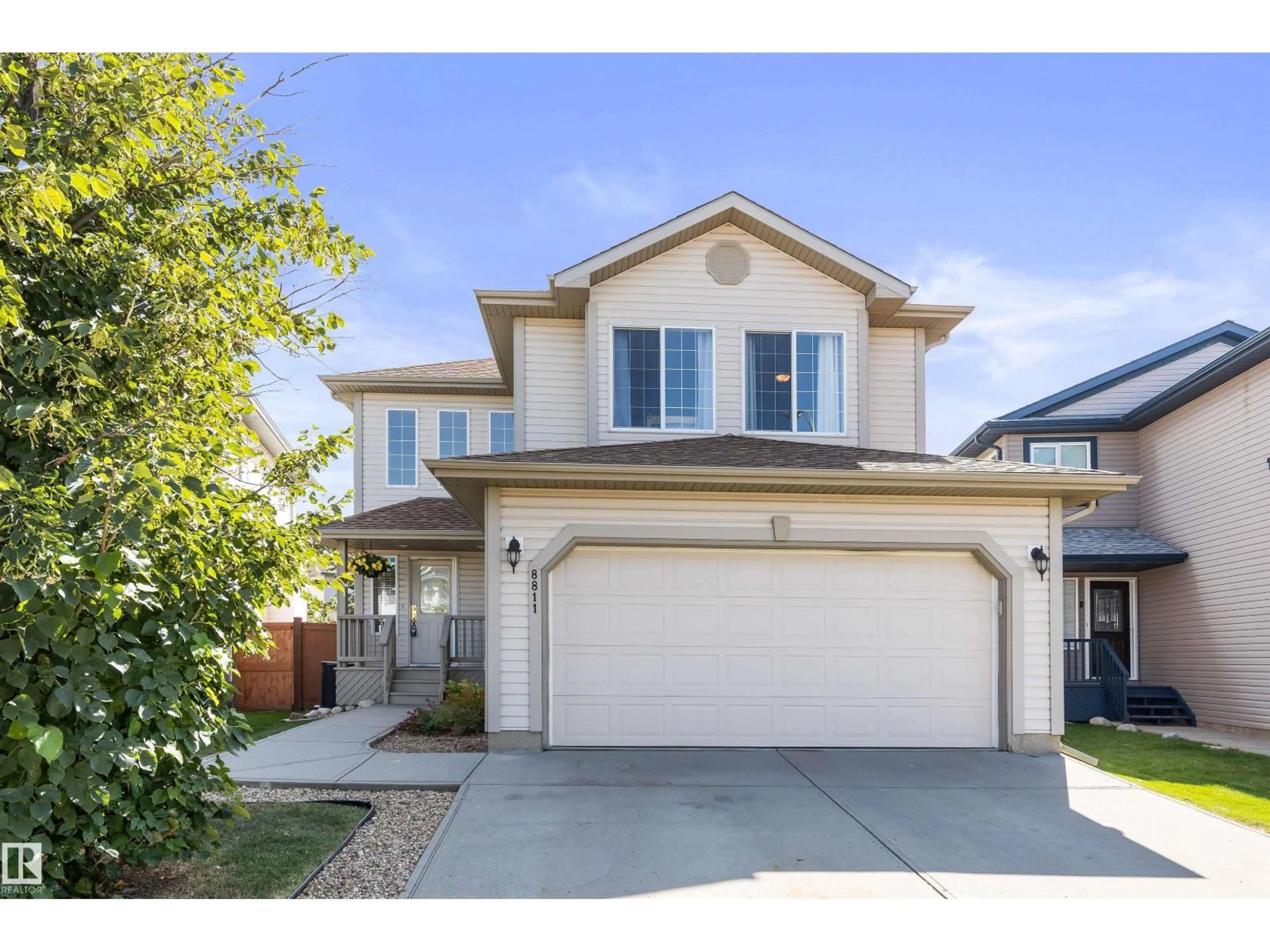 Home with vinyl exterior material, street for 8811 174 AV, Edmonton Alberta T5Z3R4