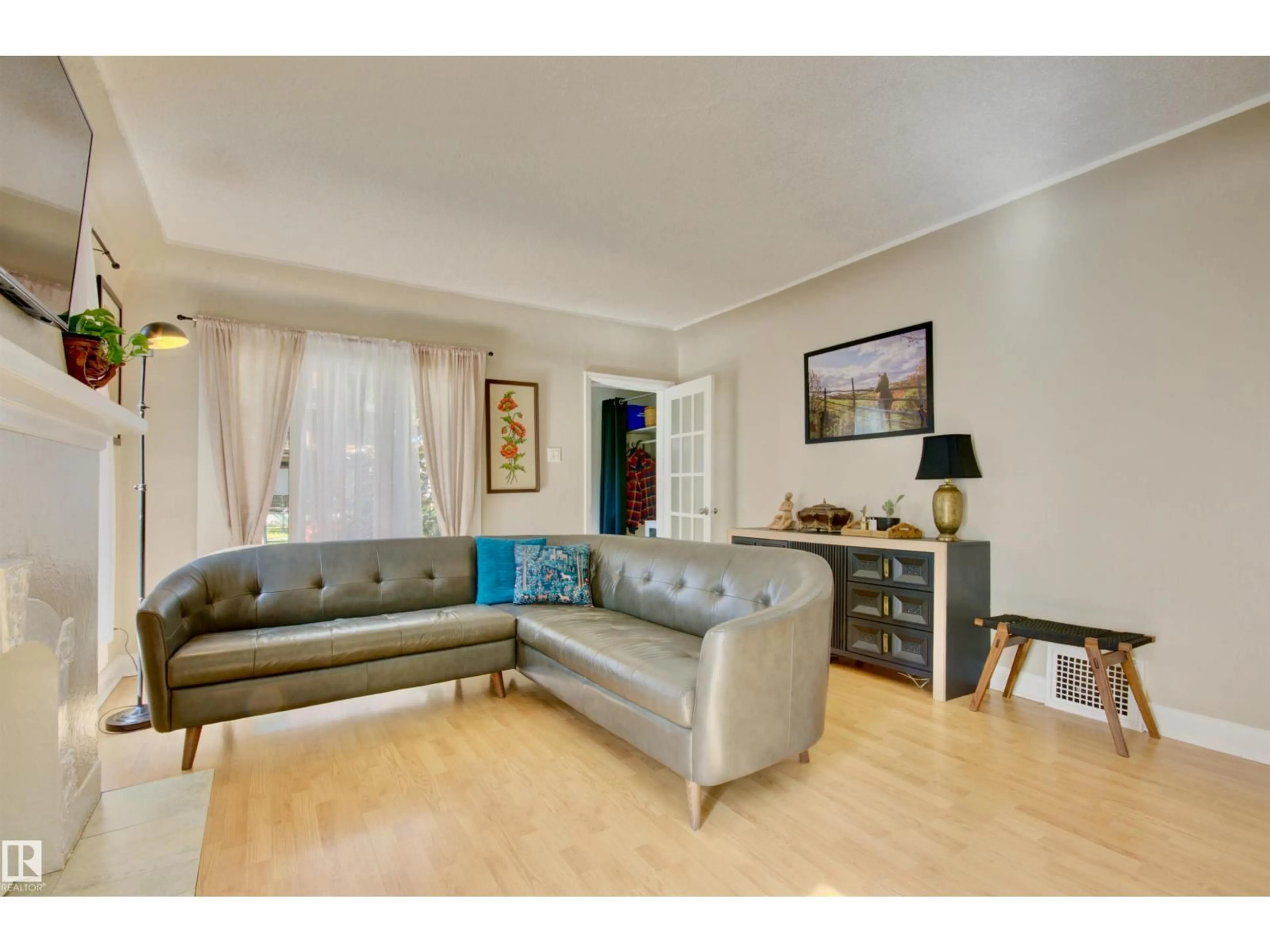 Living room with furniture, wood/laminate floor for 11319 94 ST, Edmonton Alberta T5G1H2