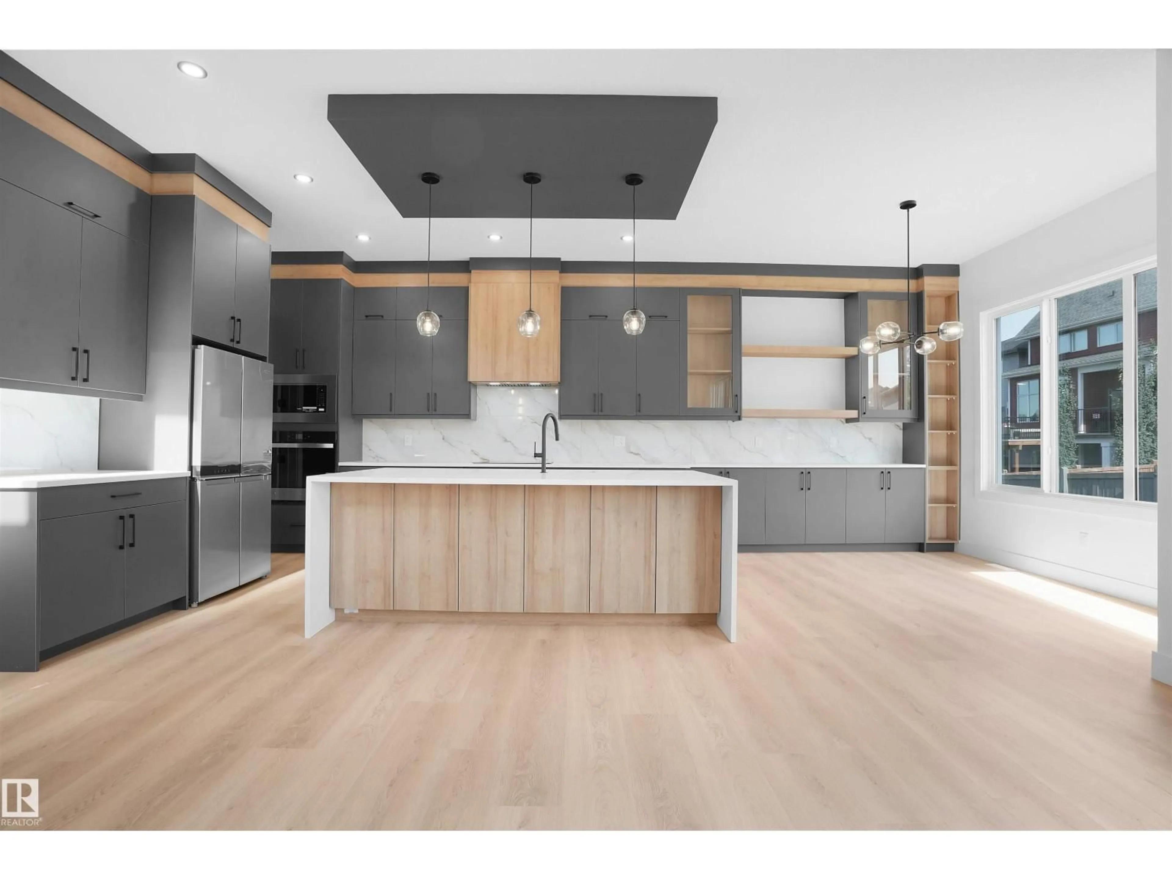 Open concept kitchen, wood/laminate floor for 1142 GYRFALCON CR, Edmonton Alberta T5S0S5
